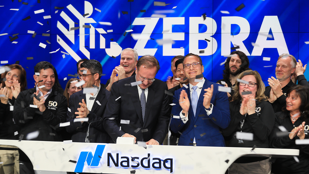 Zebra rings the Nasdaq closing market bell on May 1 at Times Square in New York City in celebration of the company’s 50th anniversary. Photography by Libby Greene/Nasdaq, Inc.