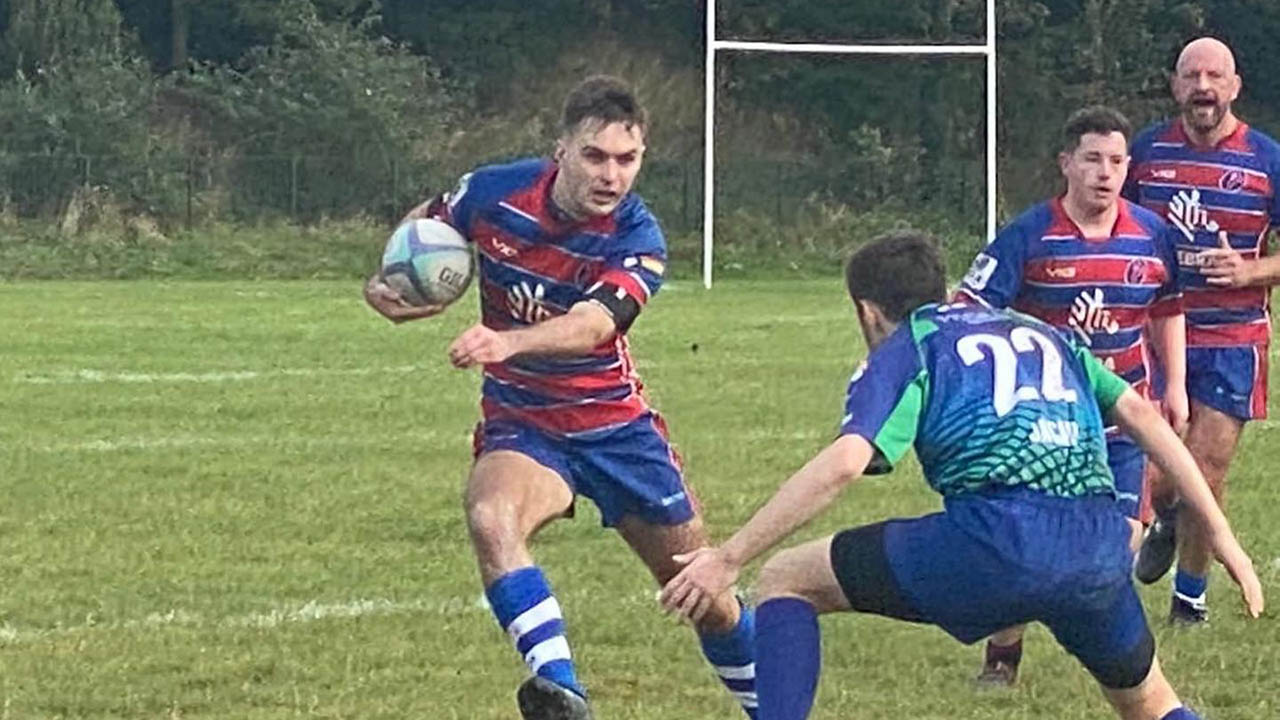 Alex Holdsworth plays in a rugby match