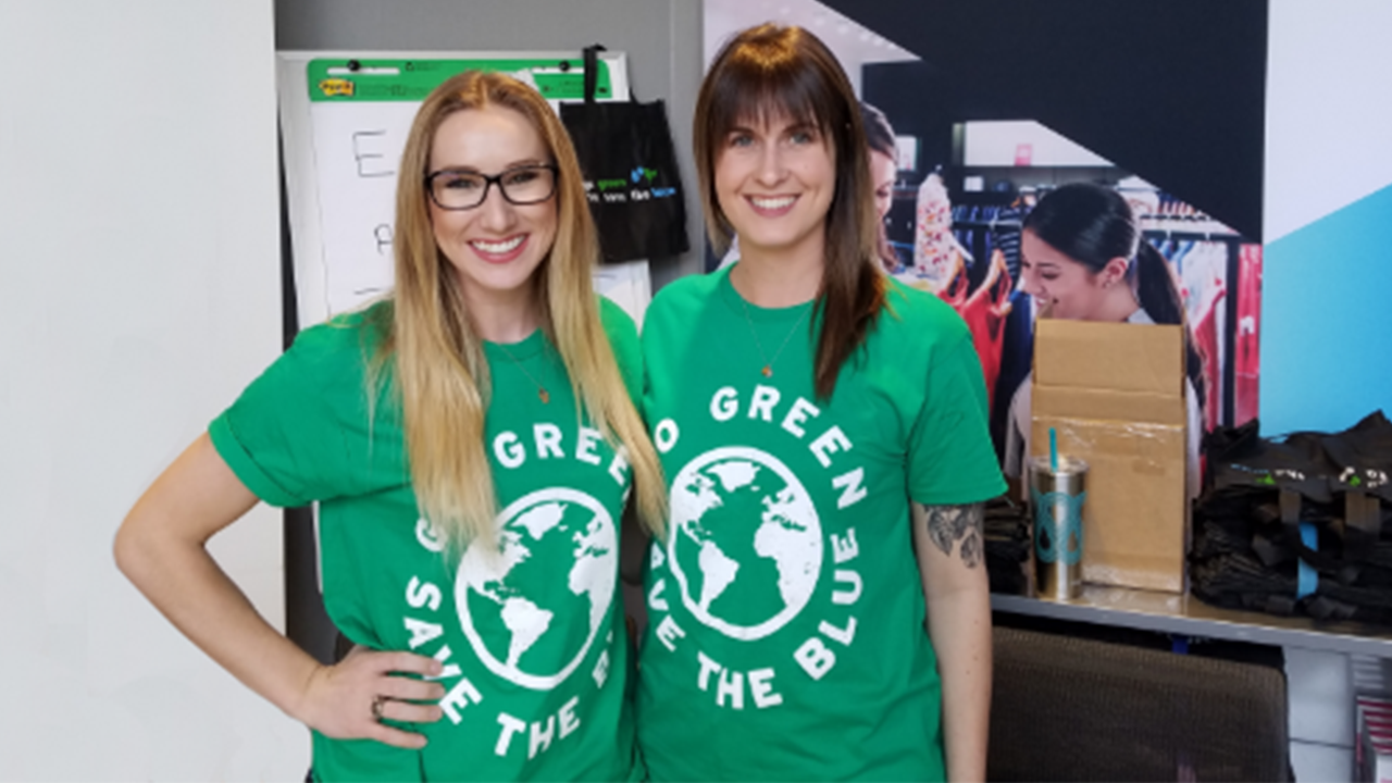 Two women wearing green Earth Day t-shirts