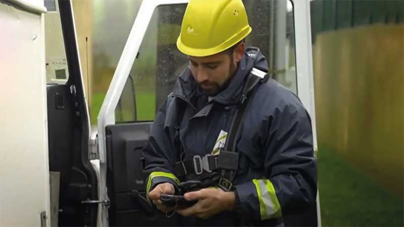 A utility worker looks at his Zebra touch computer