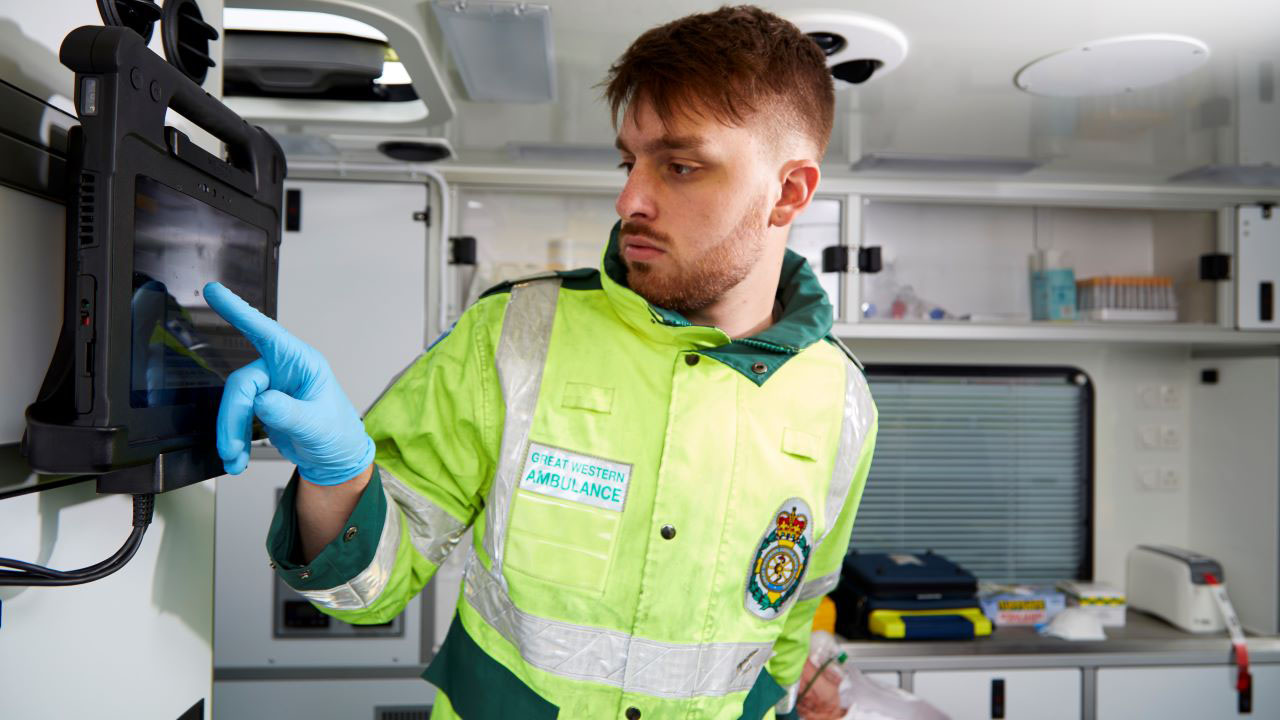 An EMT inputs patient information into a rugged tablet