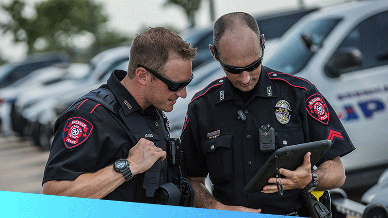 Two police offers using a rugged tablet to maintain real-time situational visibility and coordinate with other first responders.