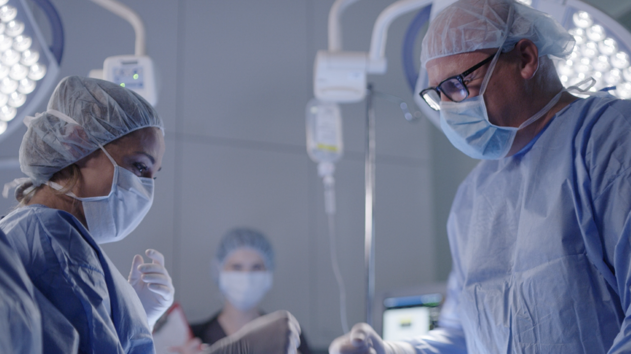 A surgeon consults with a nurse