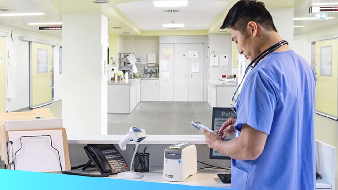 A doctor reviews a patient's record on his handheld mobile computer