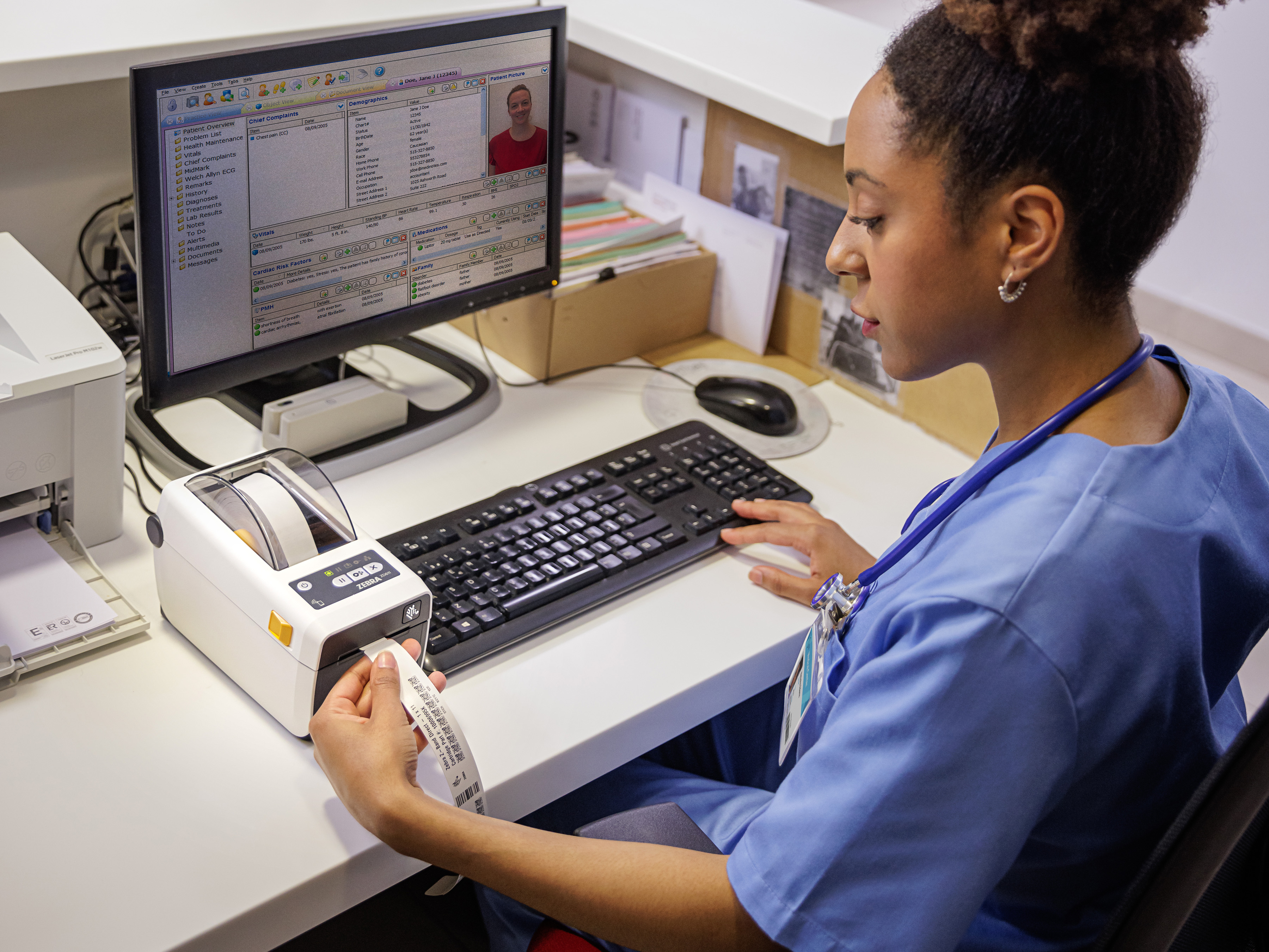 Healthcare employee printing a label on a Zebra ZD611D-HC printer with zBand for check-in at a hospital 