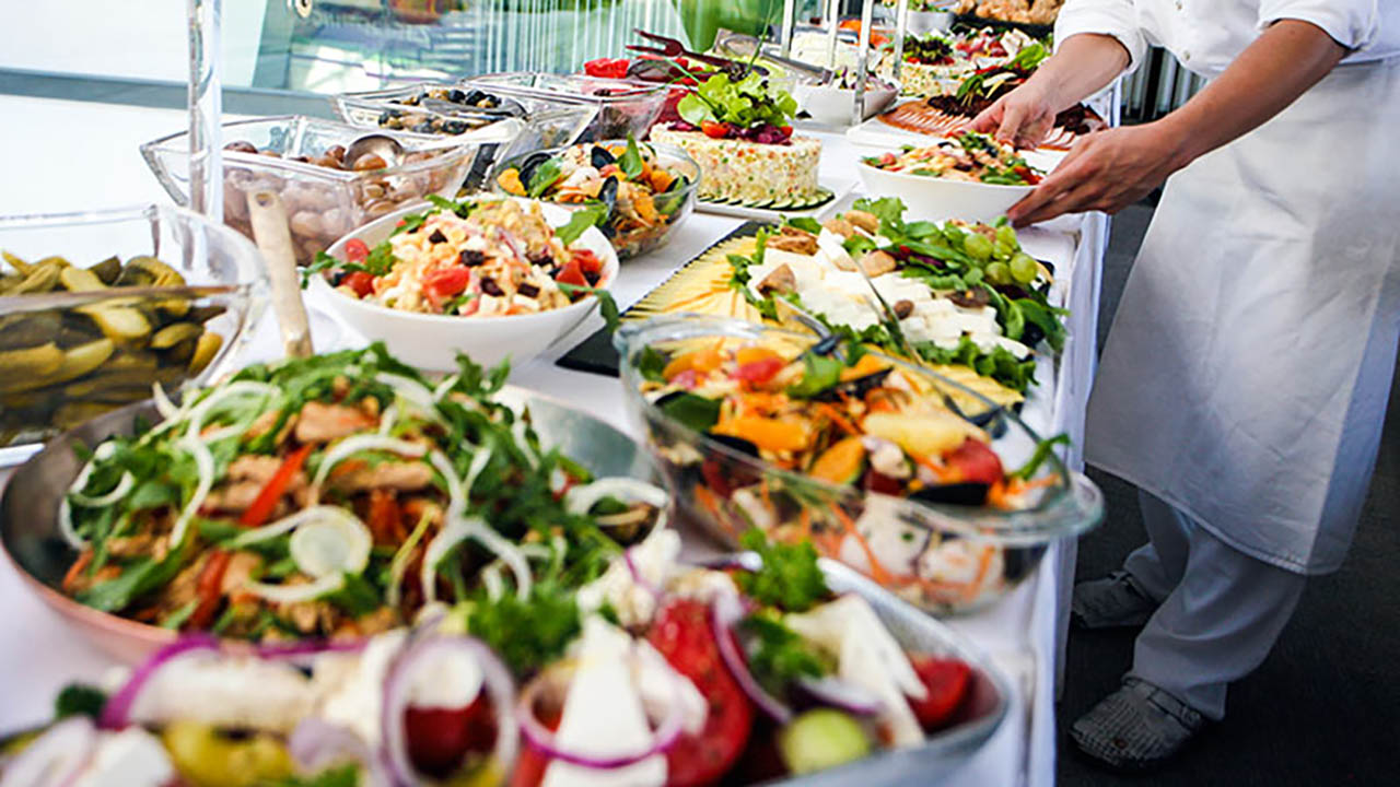 A chef prepares fresh salads at a QSR