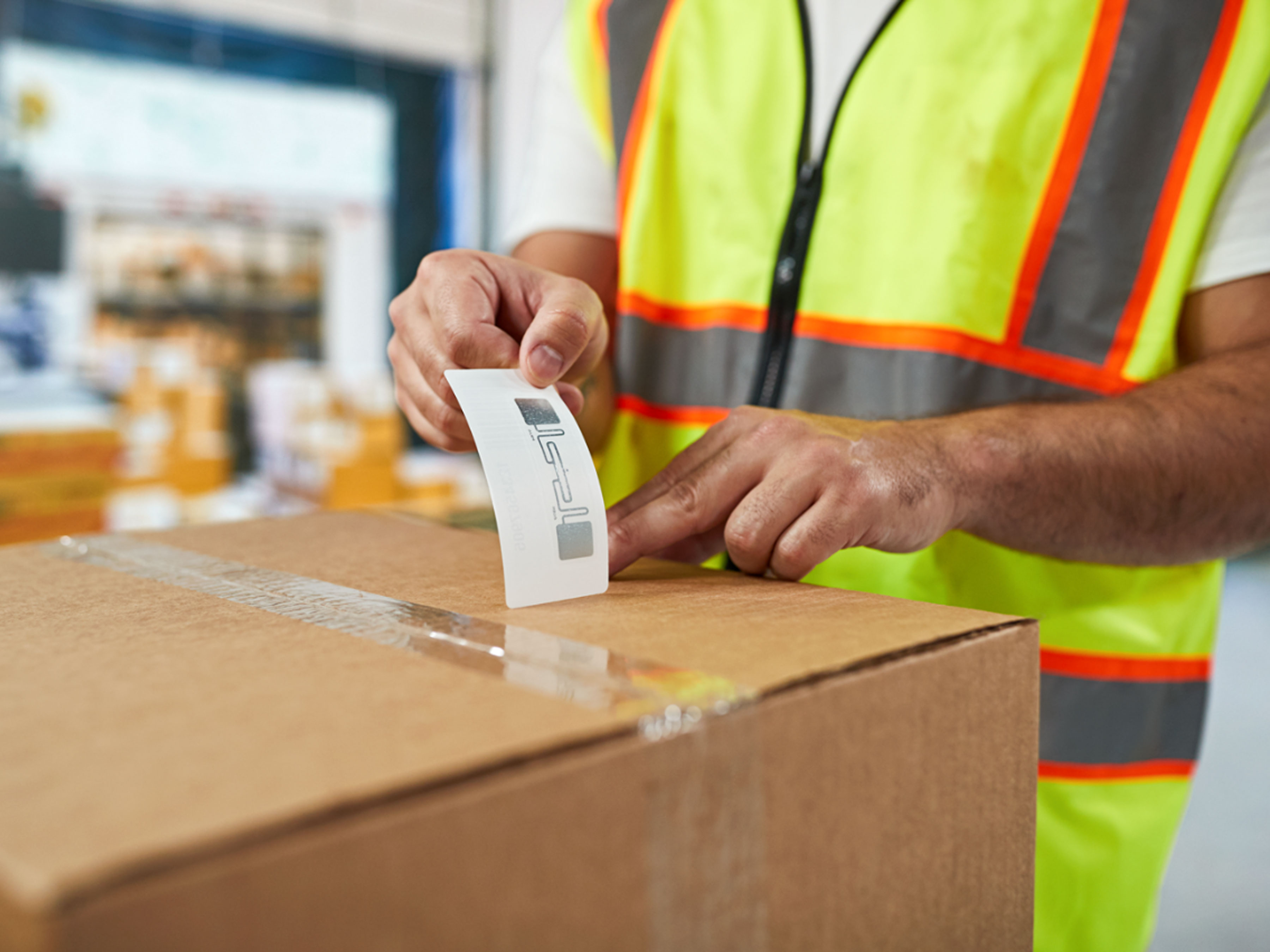 Manufacturing, Photography Application, Transportation RFID Labeling, 4:3, 3600 Delivery guy sticking RFID label