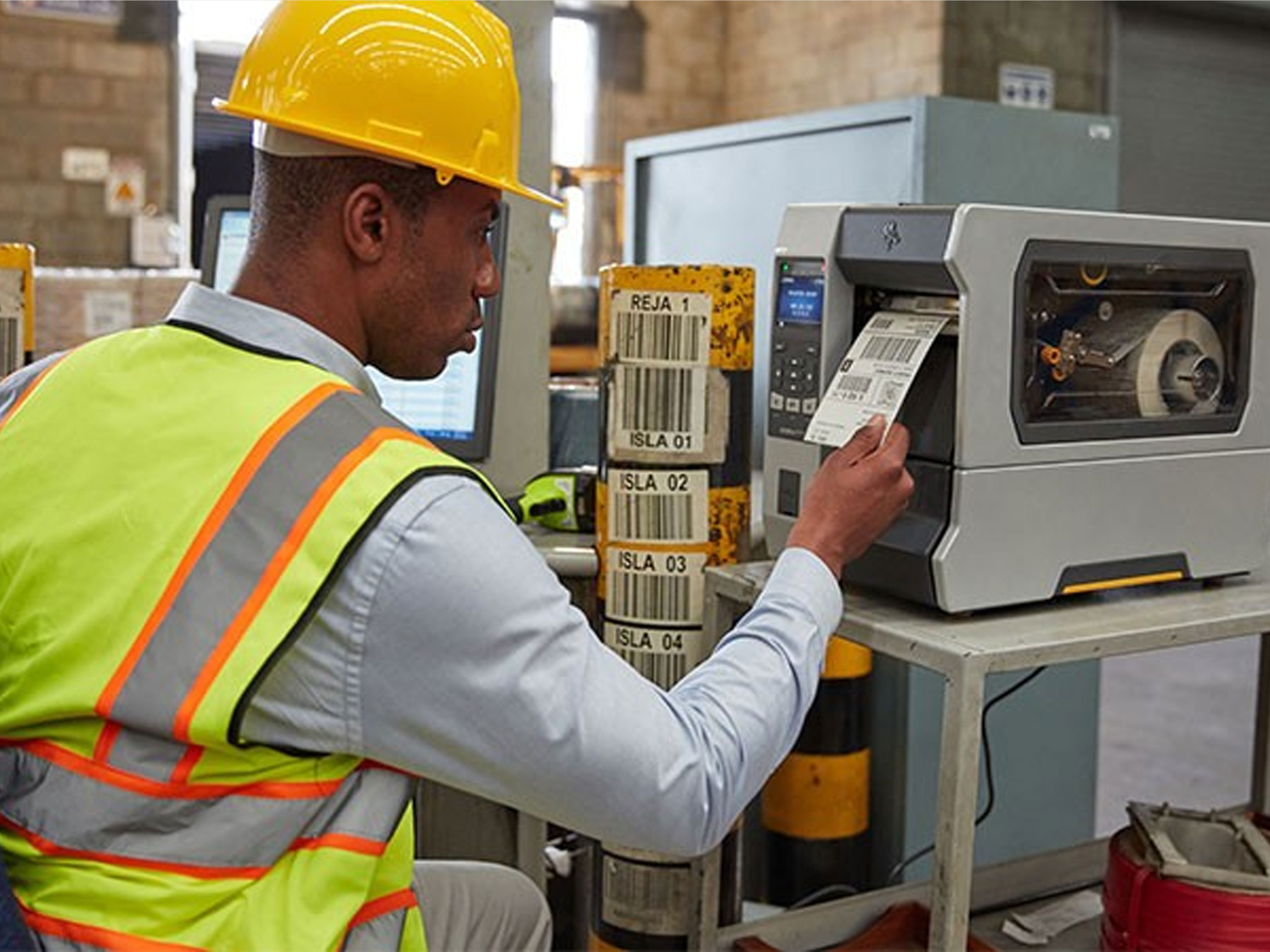 Warehouse worker printing label from Zebra industrial printer