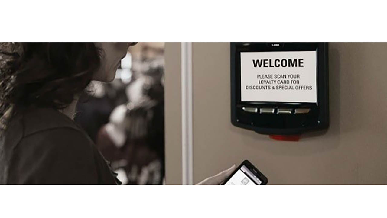 A woman looks at a check-in kiosk