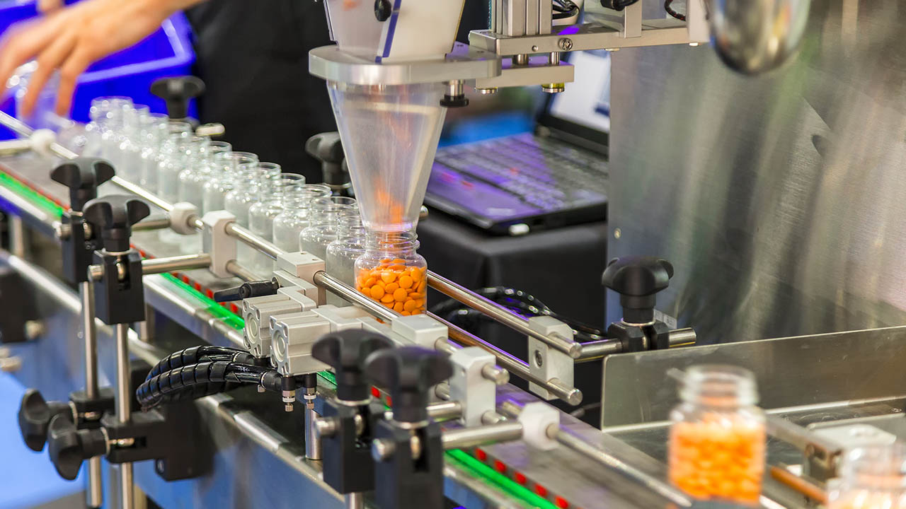 Pill bottles are filled on a pharmaceutical manufacuring line