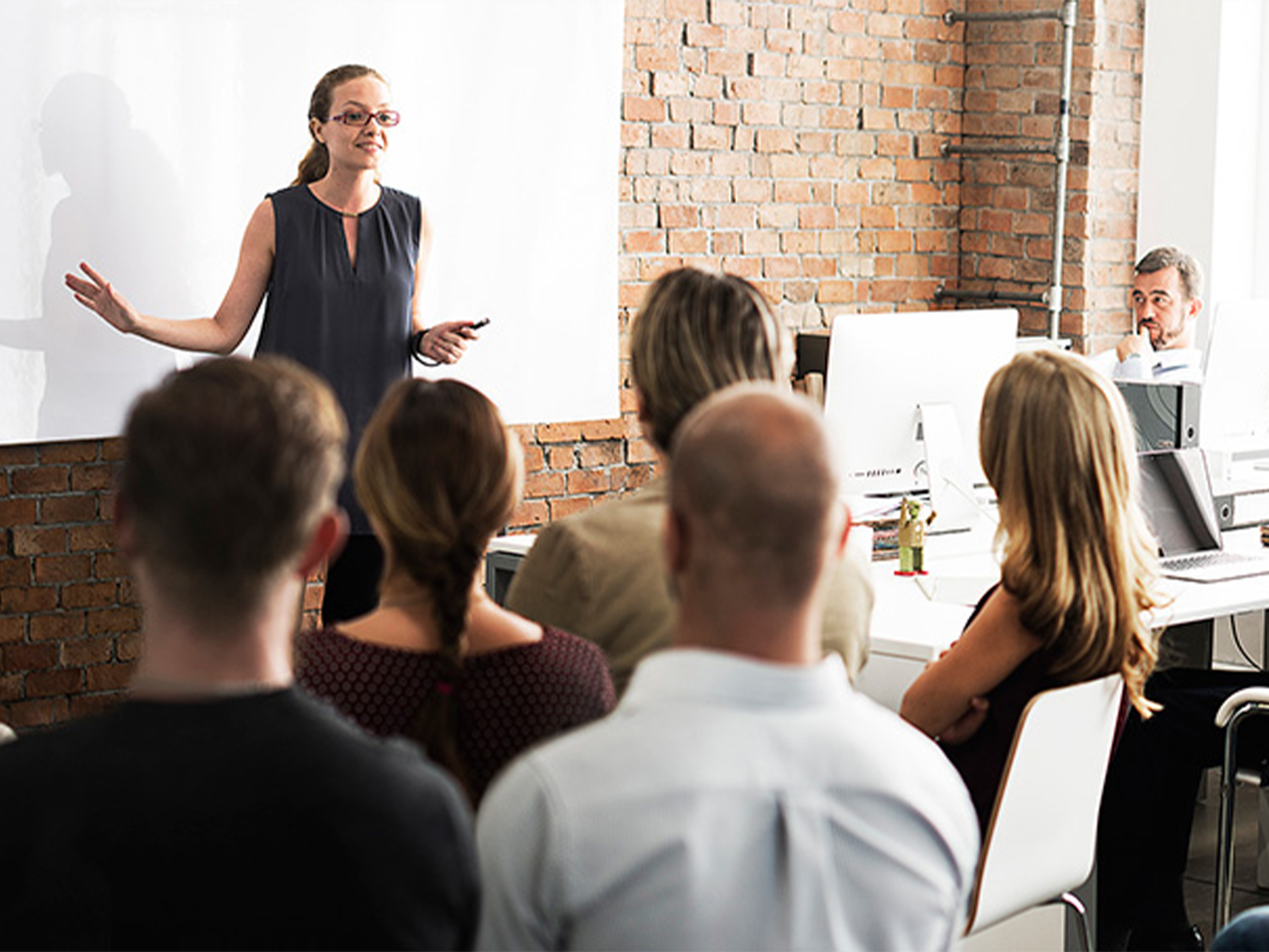 woman teaching a classroom of adults