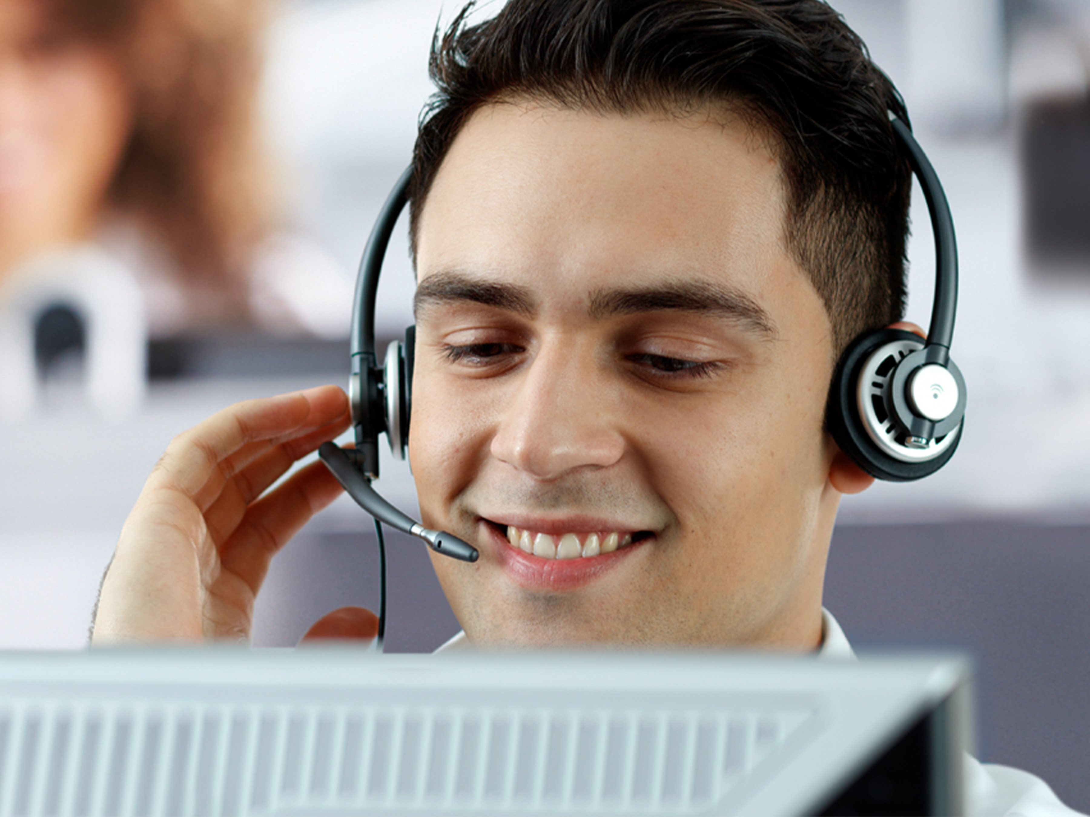 man with headset in front of a computer 