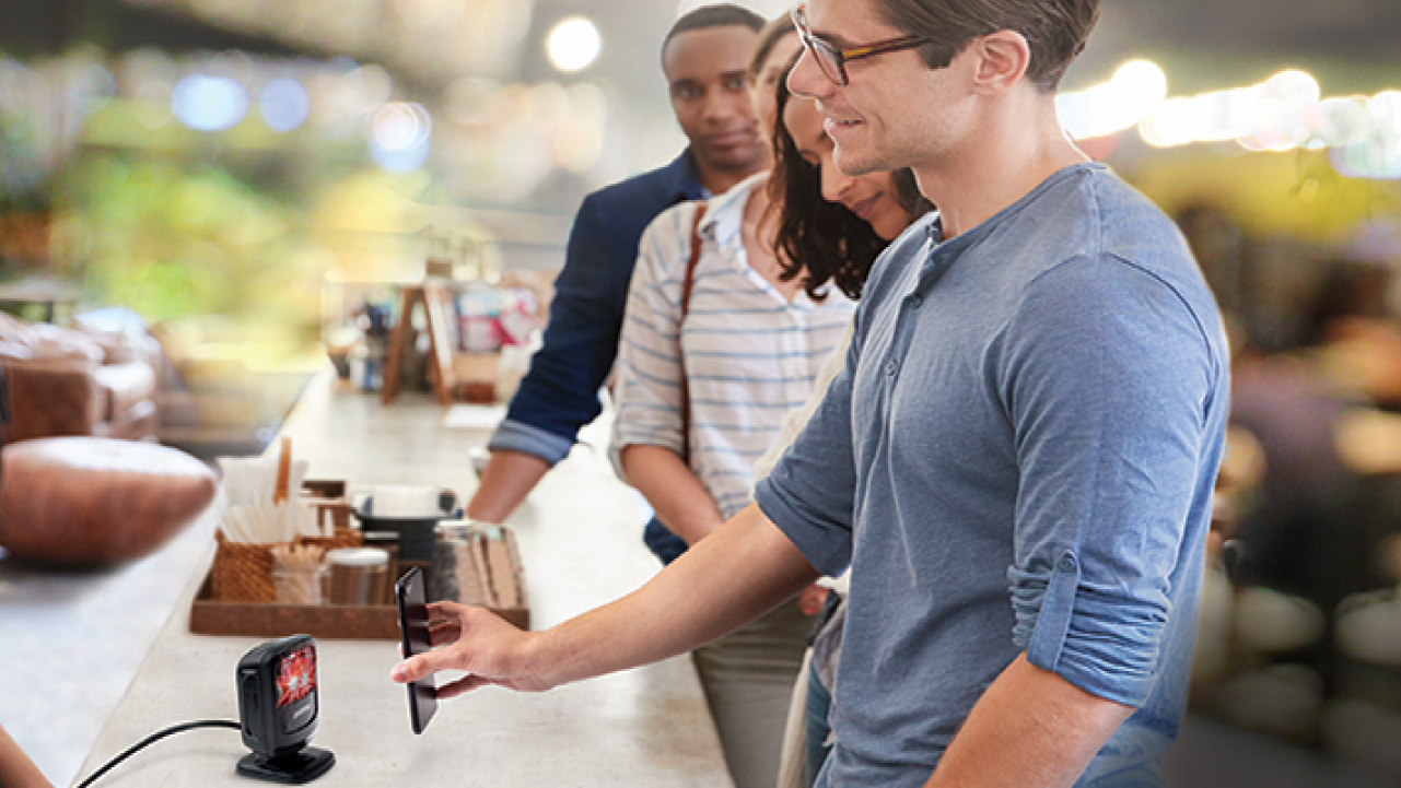 Customers use a self-scanning checkout solution at a bakery