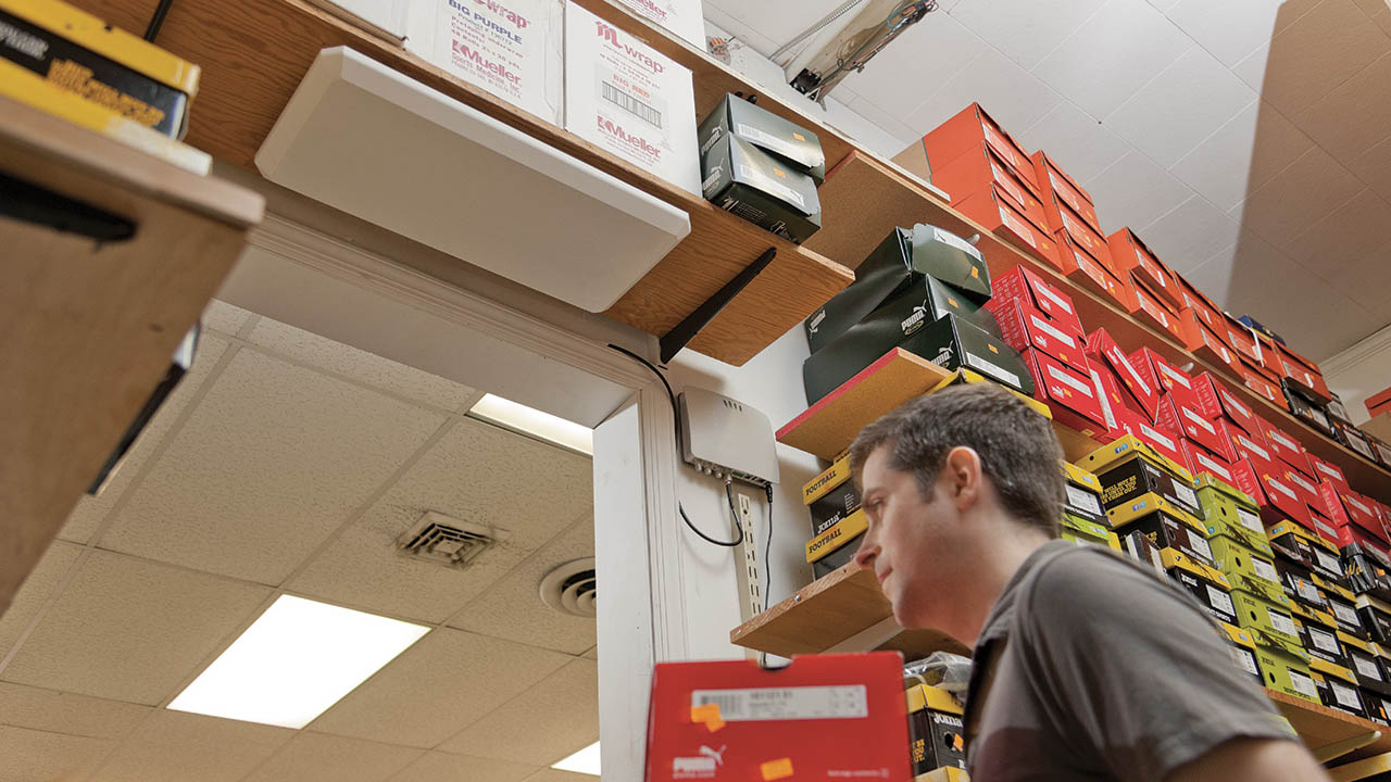 A man walks under an RFID sensor as he exits as storage room 