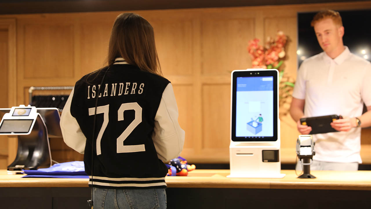 A New York Islanders hockey team fan makes a purchase at the team's retail store in the arena