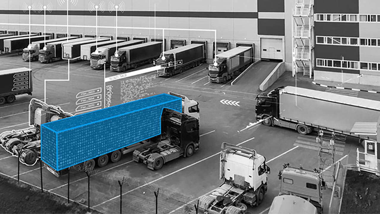 Trucks pull in and out of a distribution center loading area