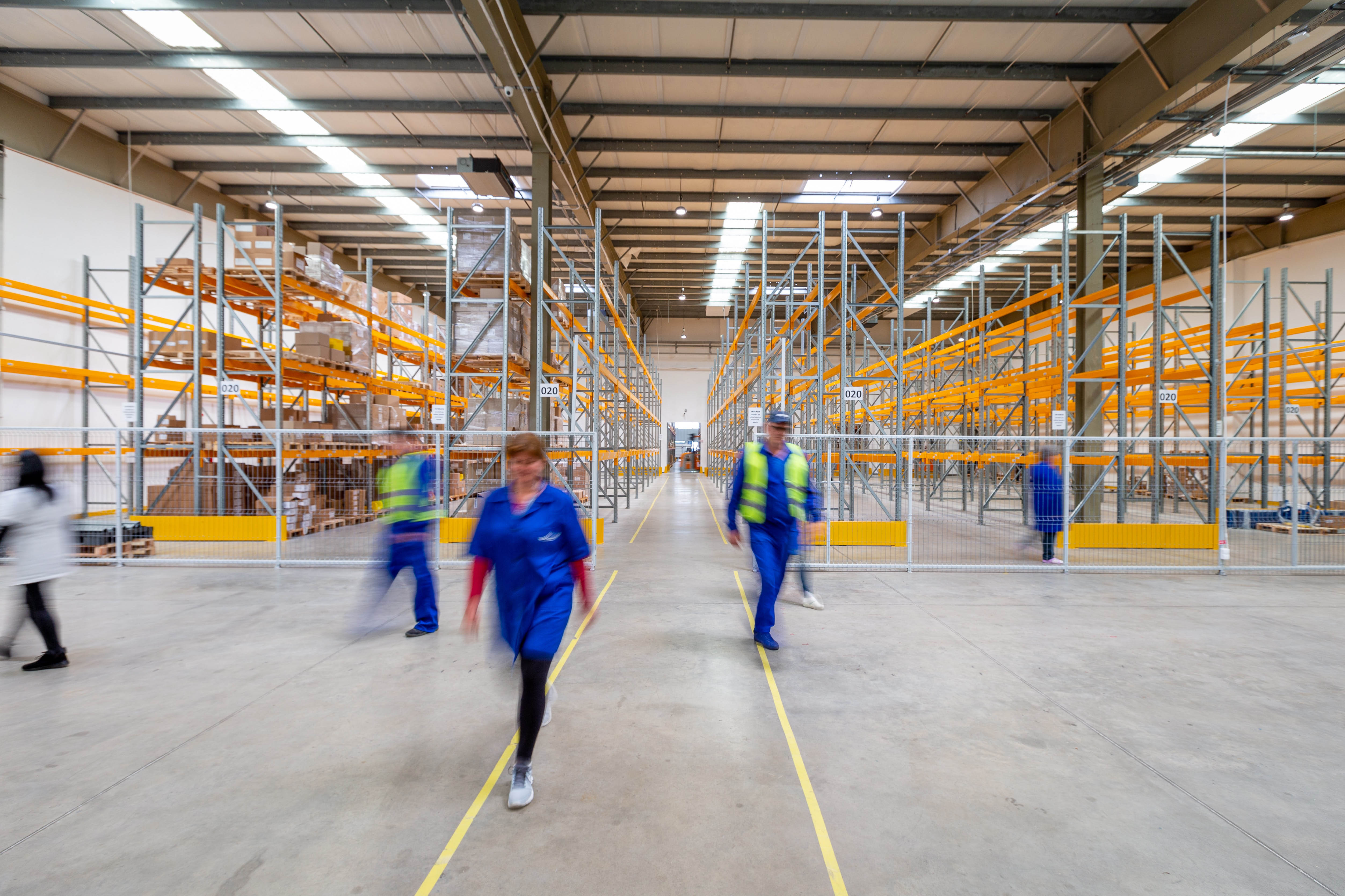 People smiling as they leave a warehouse to head home