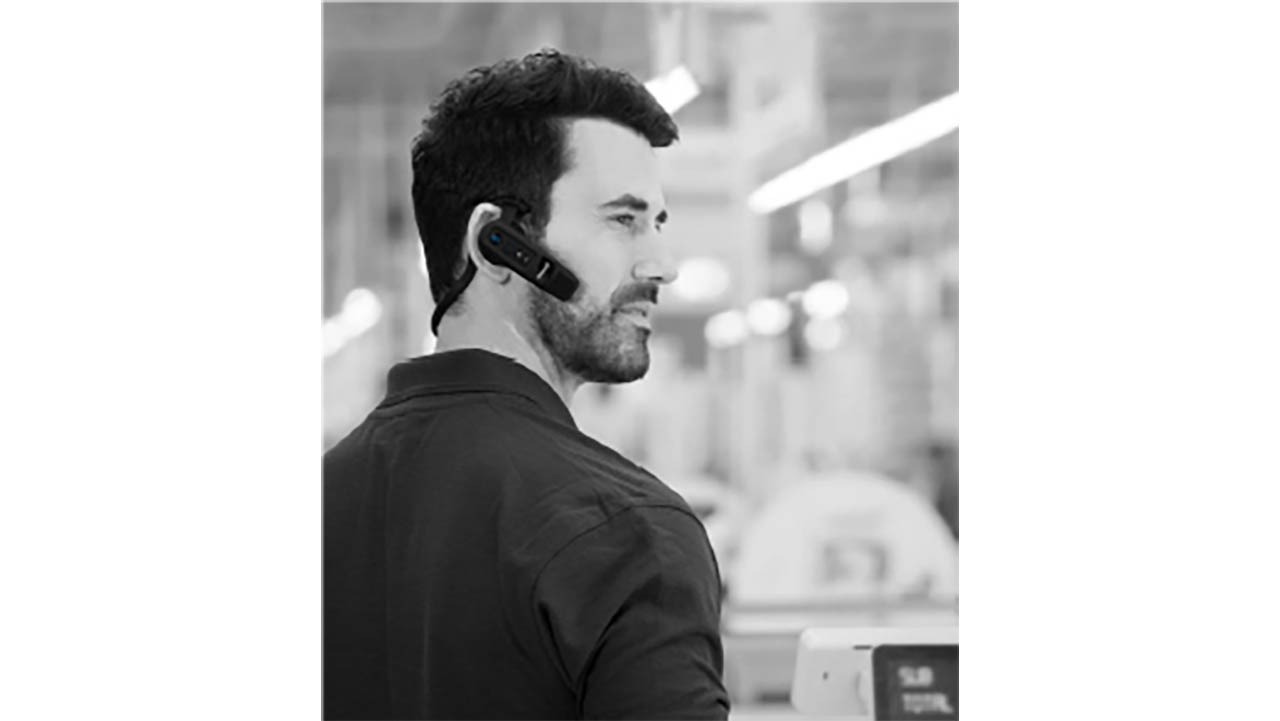 A retail store associate wears a BlueParrott headset