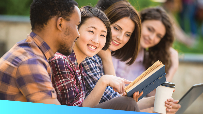 A group of millennials reviewing a textbook together