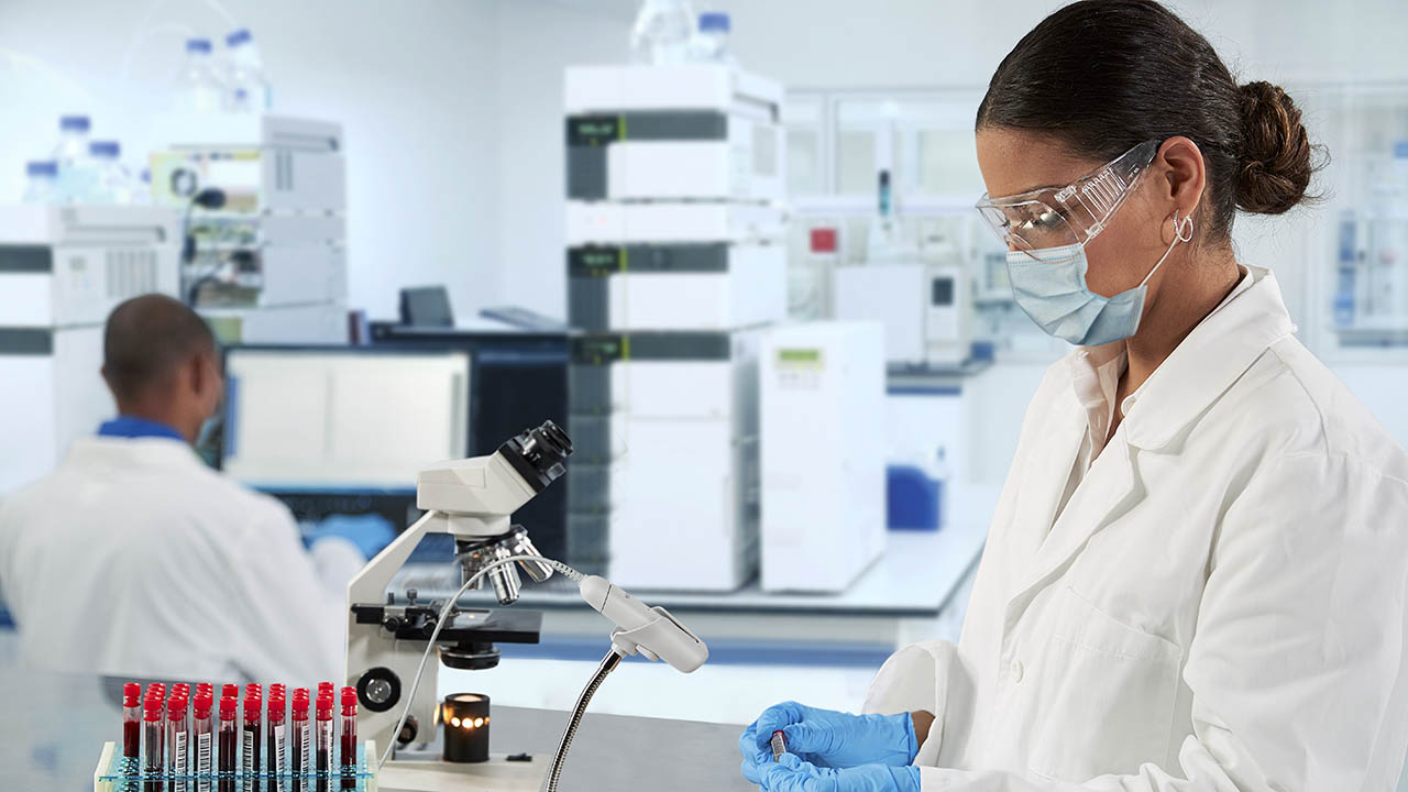 A lab technician uses a Zebra CS60-HC convertible scanner to scan a blood vial