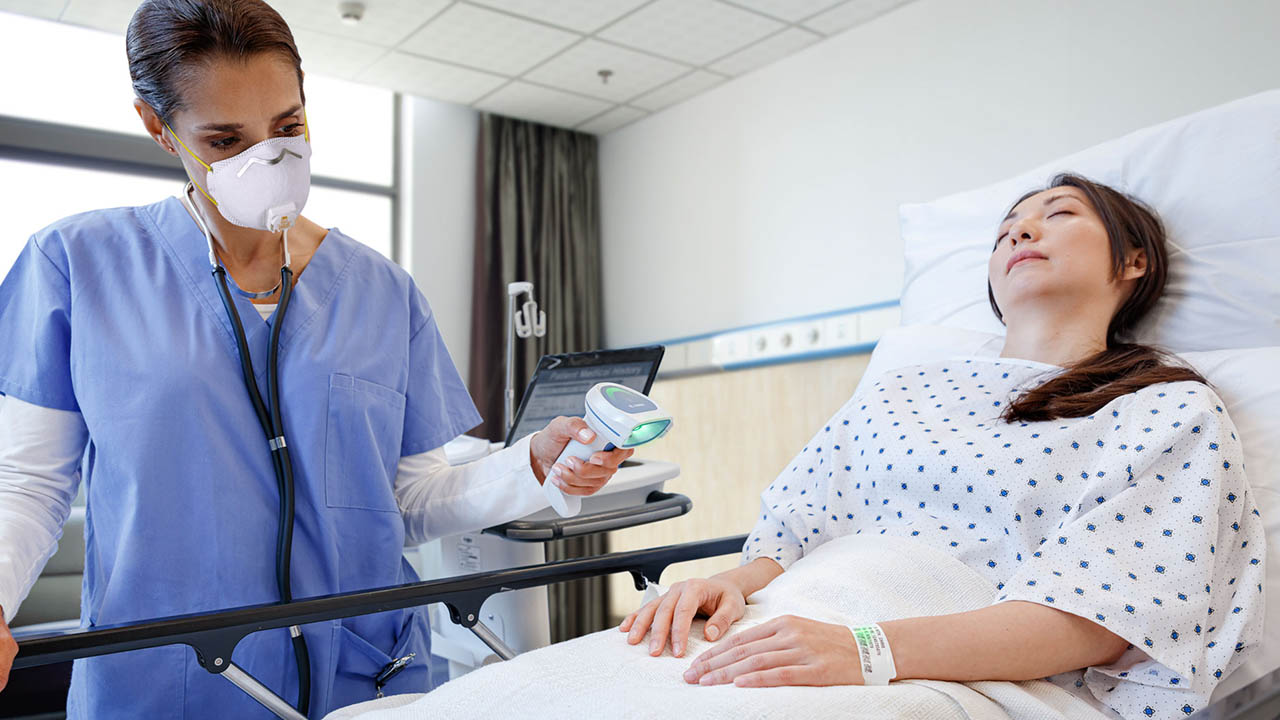 A nurse scans a patient's wristband