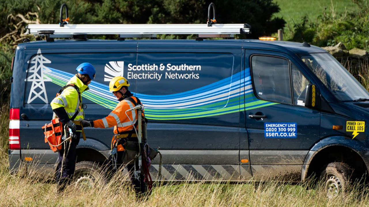 Scottish and Southern Electricity Network workers stand outside their vehicle