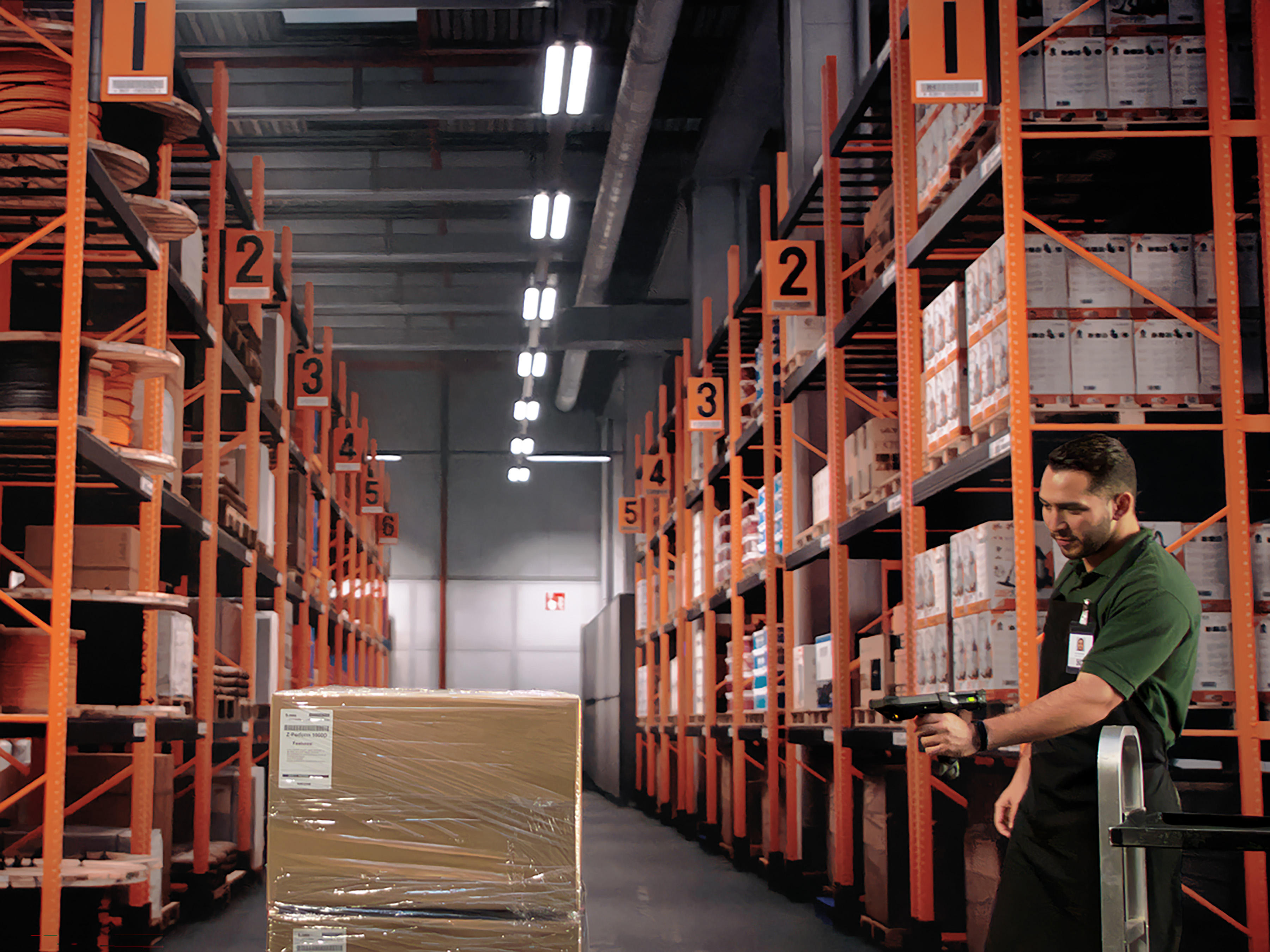 A warehouse associate retrieves information from his mobile computer about where to put away incoming goods