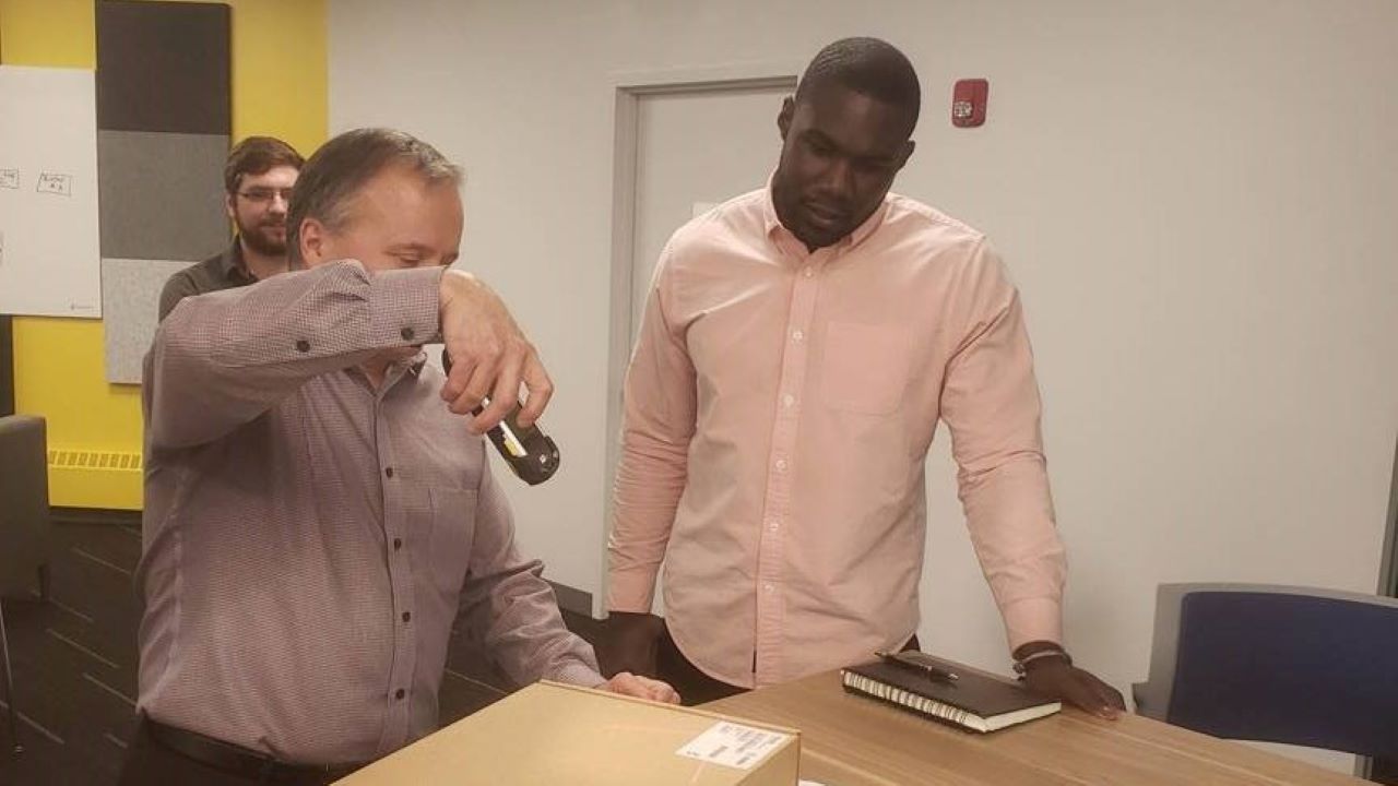 NFL defensive lineman Eric Lee get a hands-on demo of Zebra technology at the Holtsville office during hs three-week externship