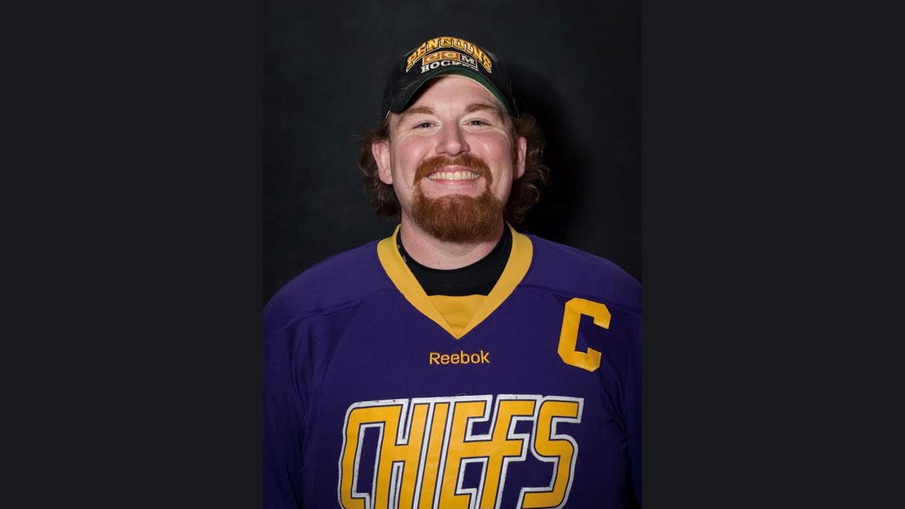 A photo of Zebra Technologies employee Nicholas Heenan smiling in his hockey uniform after his weight loss