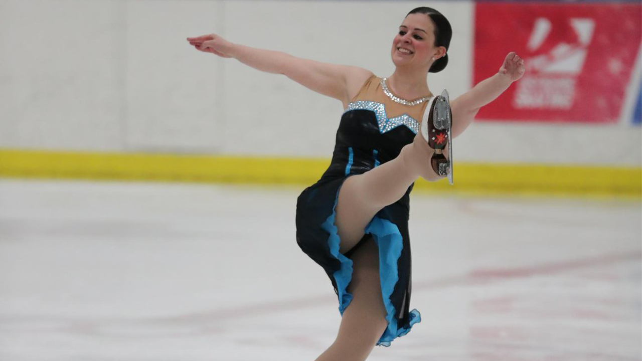 Sally-Anne Schmick performing a spin on the ice in a competition.