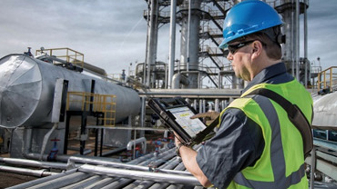 An energy worker uses a HazLoc-certified rugged tablet to inspect equipment