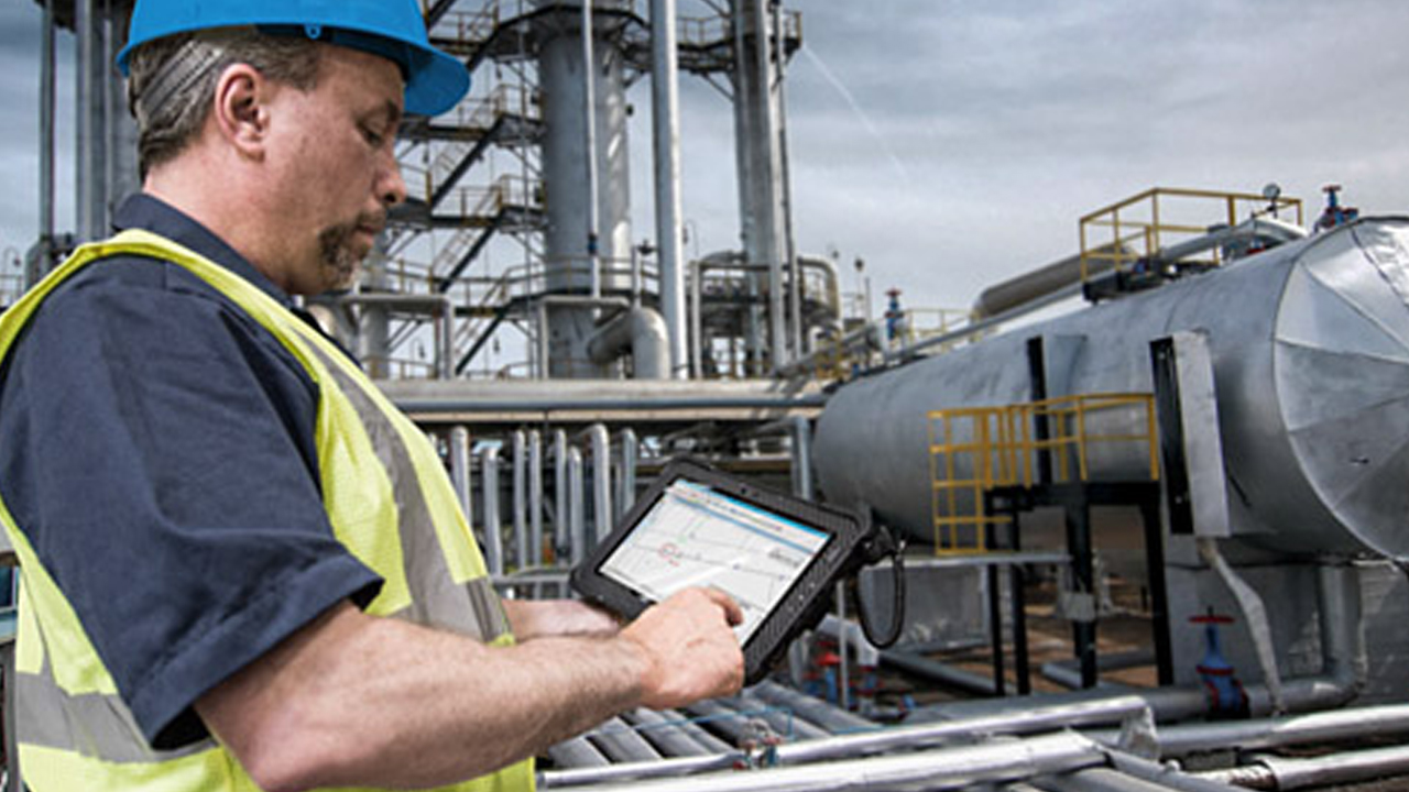 A worker uses an ATEX-certified Zebra rugged tablet to review equipment information in a Hazardous Location