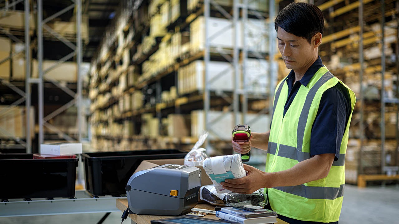 A warehouse worker uses the Zebra 3600 Series Ultra-Rugged Scanner to scan the barcode on a picked item