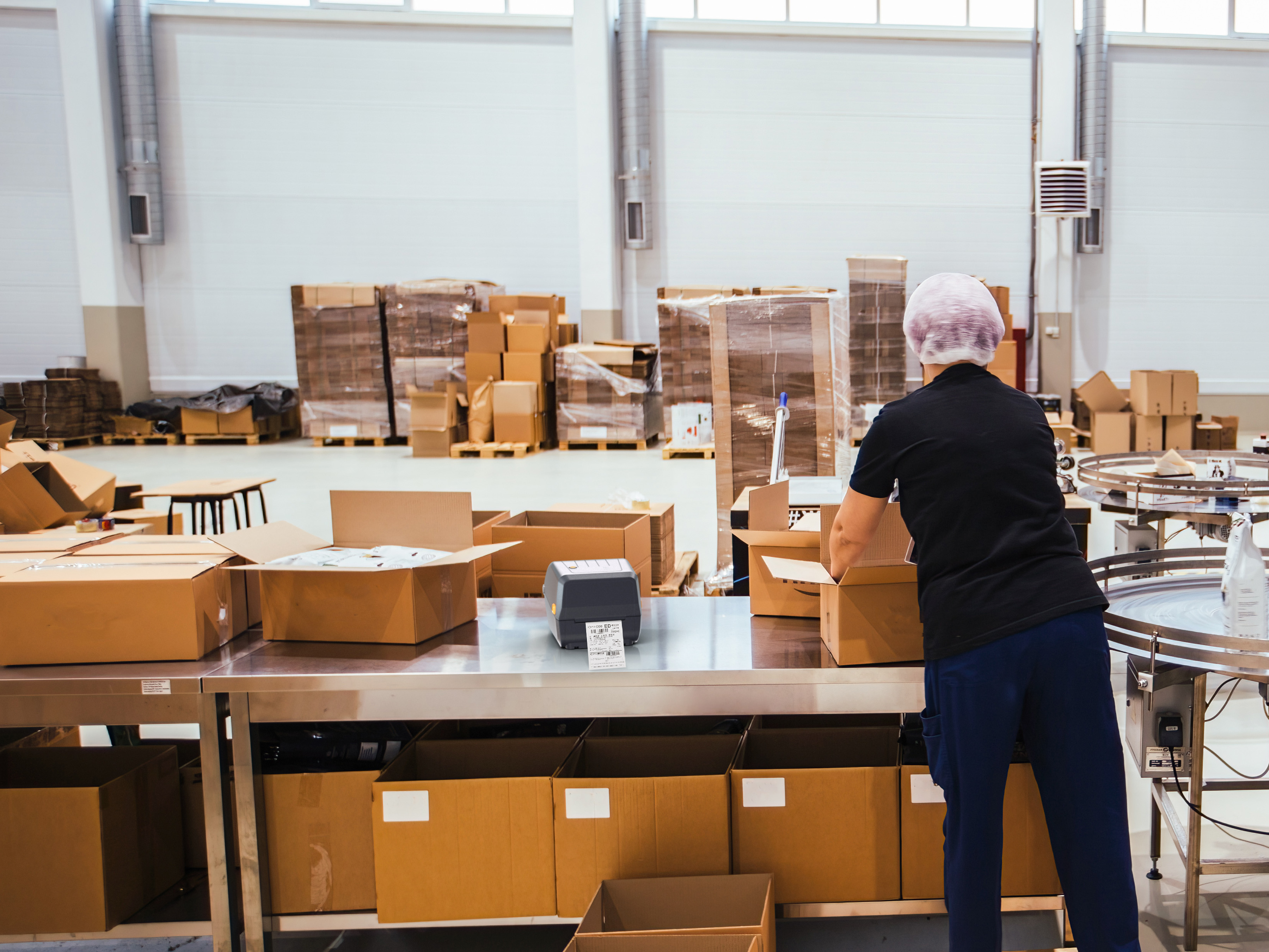 A warehouse worker prepares orders for shipment