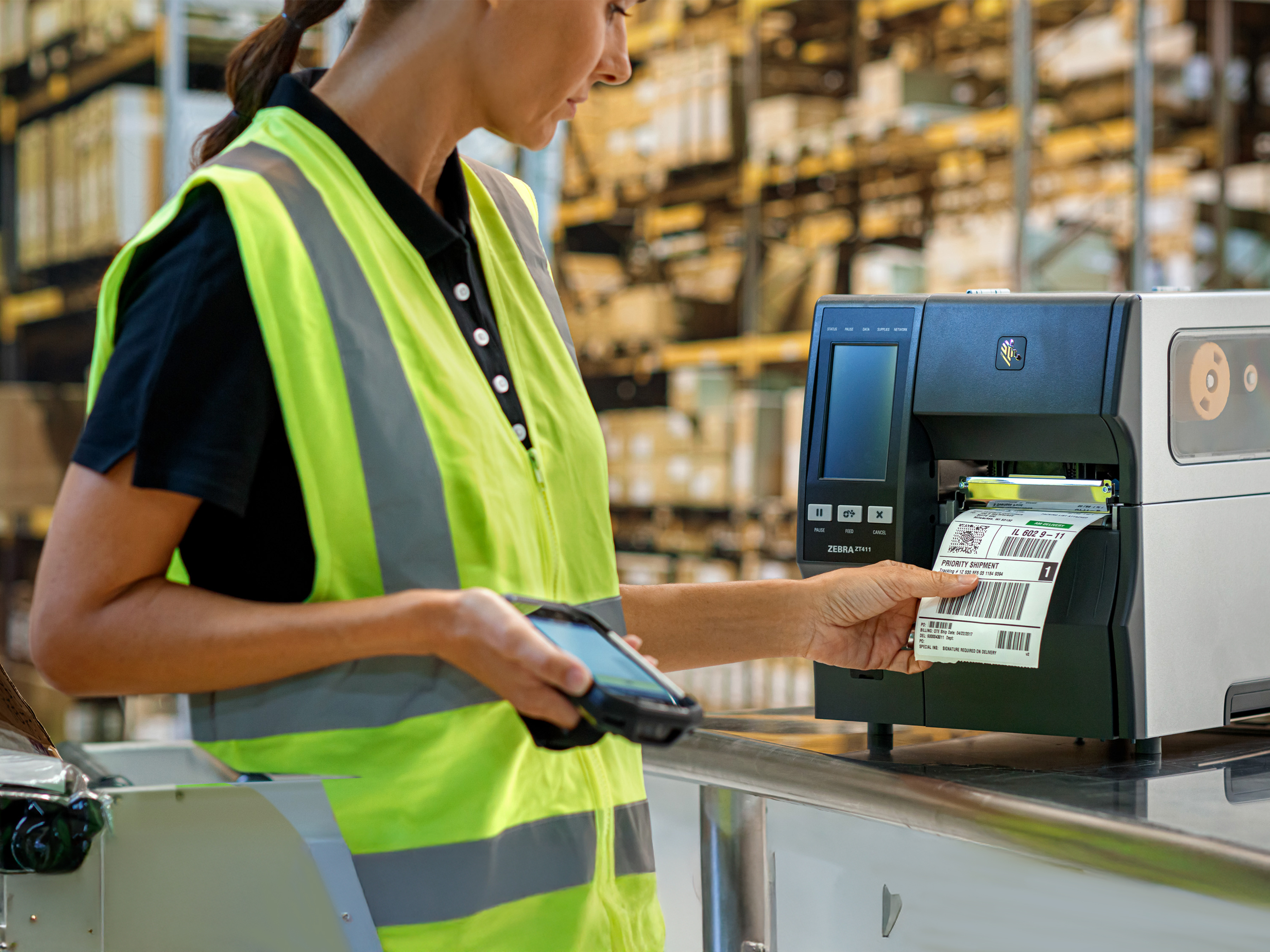 Fulfillment Worker using a Zebra industrial printer to print a shipping label. 