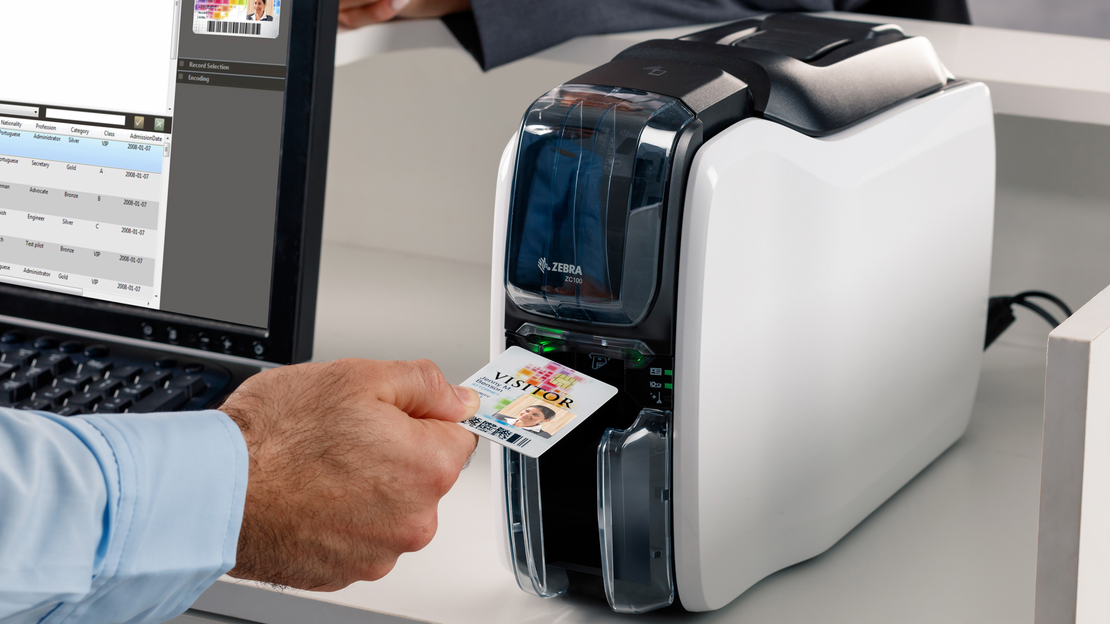 Hospitality employee using a Zebra ID Card Printer to create a visitor ID.