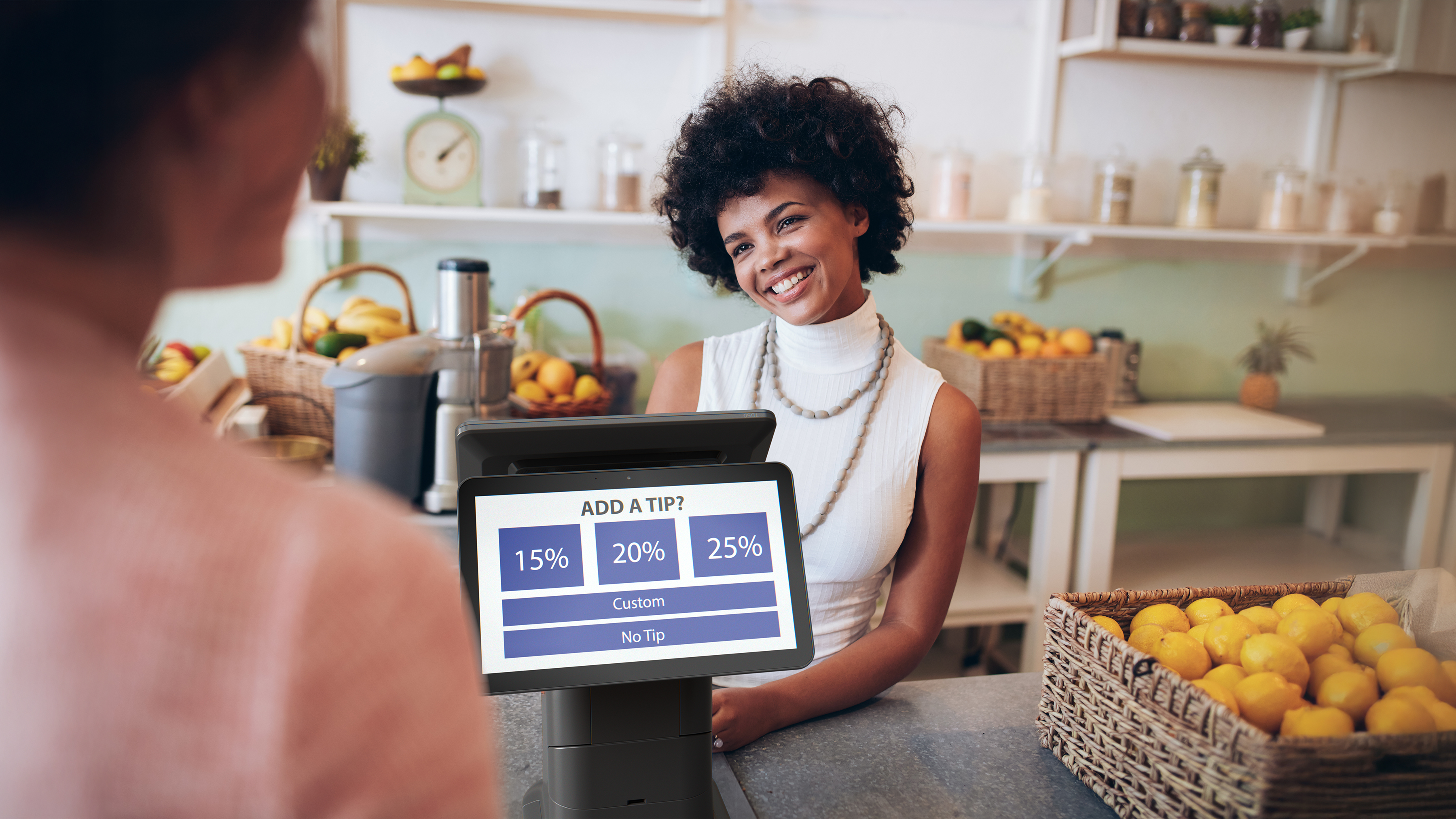 Cashier using a Zebra Interactive Kiosk to process a sale in a restaurant.