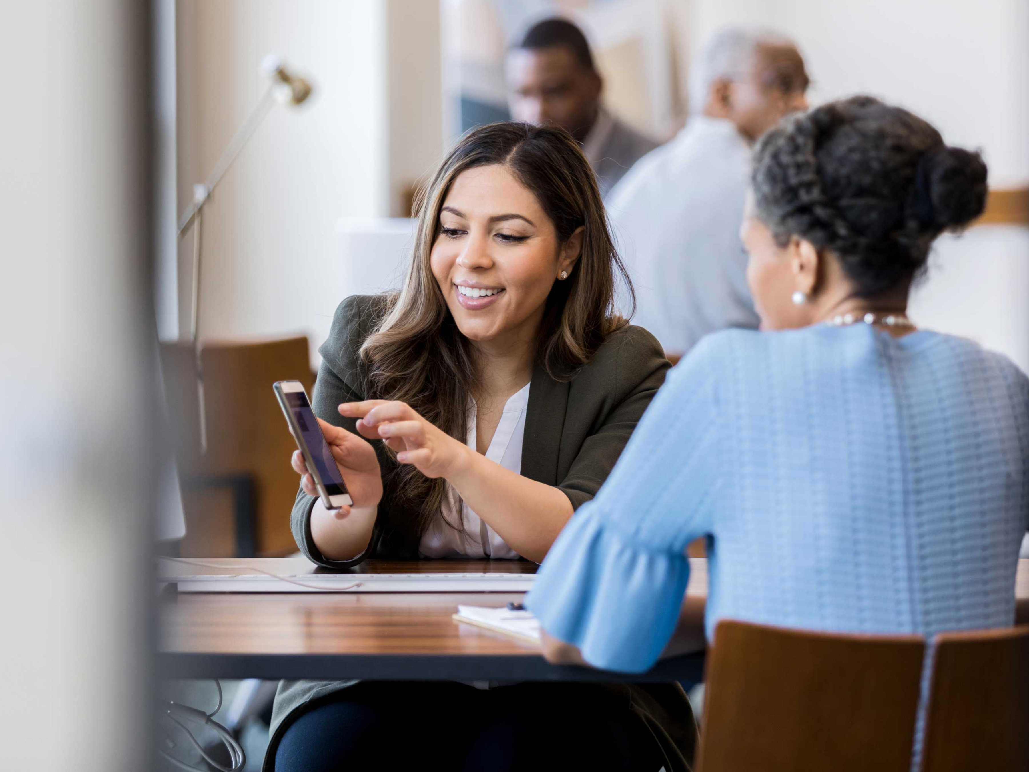 Two women having a discussion in a meeting