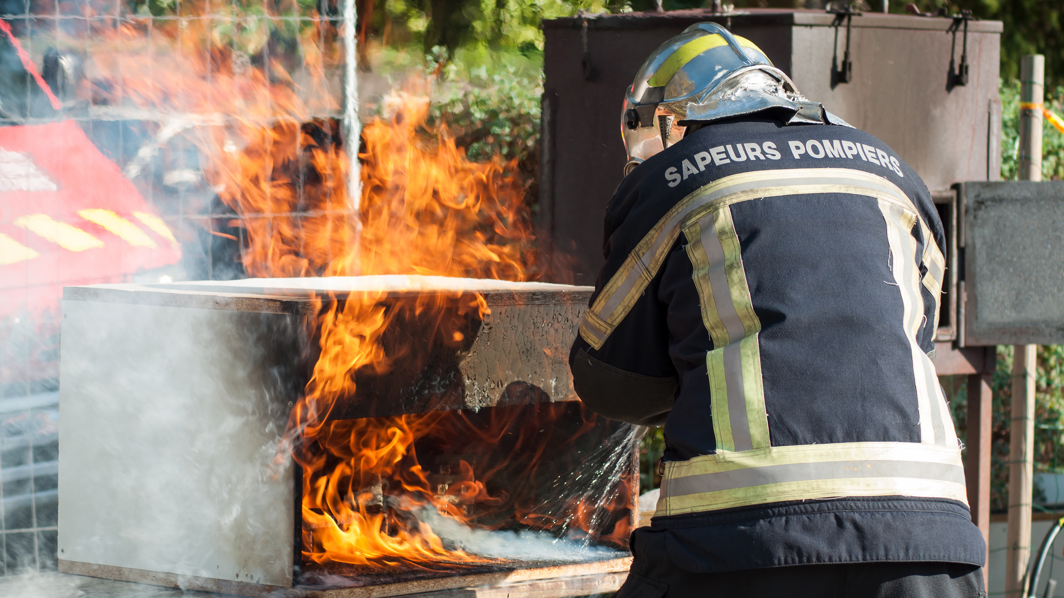 public sector photography website fire officer putting fire out back