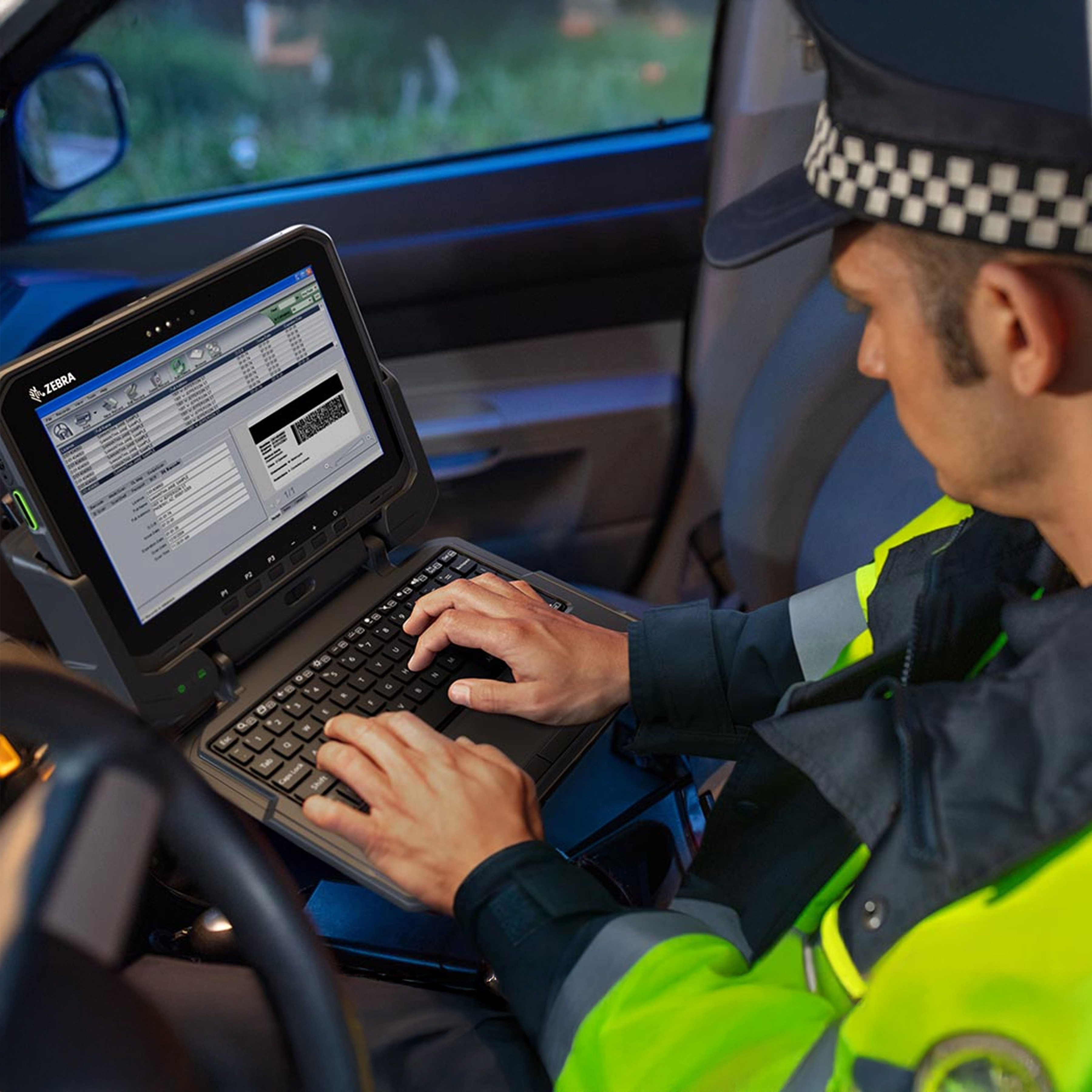 public sector photography website police officer car typing tablet keyboard