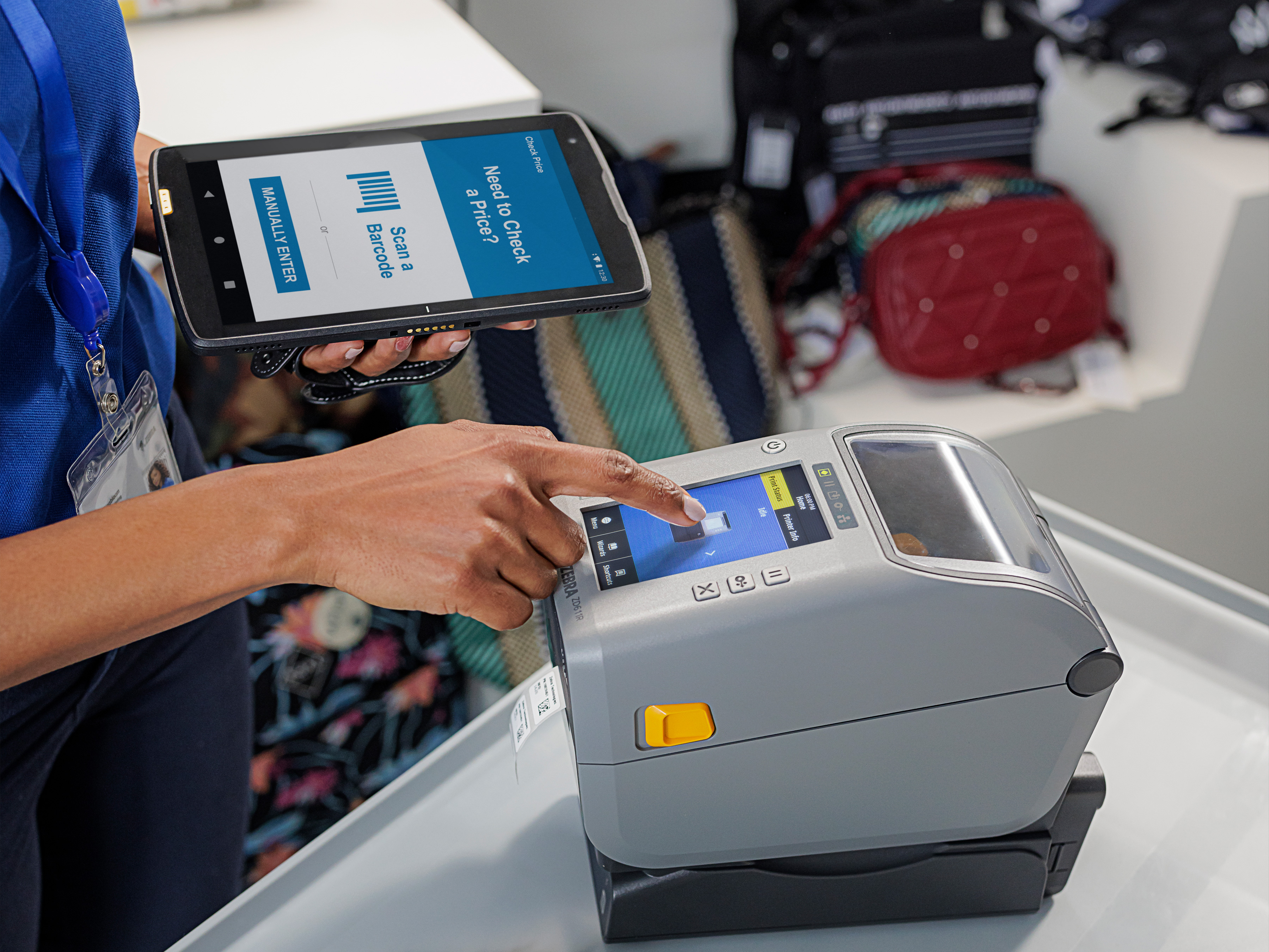 Retail worker using a tablet to print a label with a Zebra desktop printer.