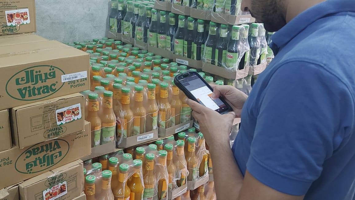 Worker using a handheld mobile computer for inventory.