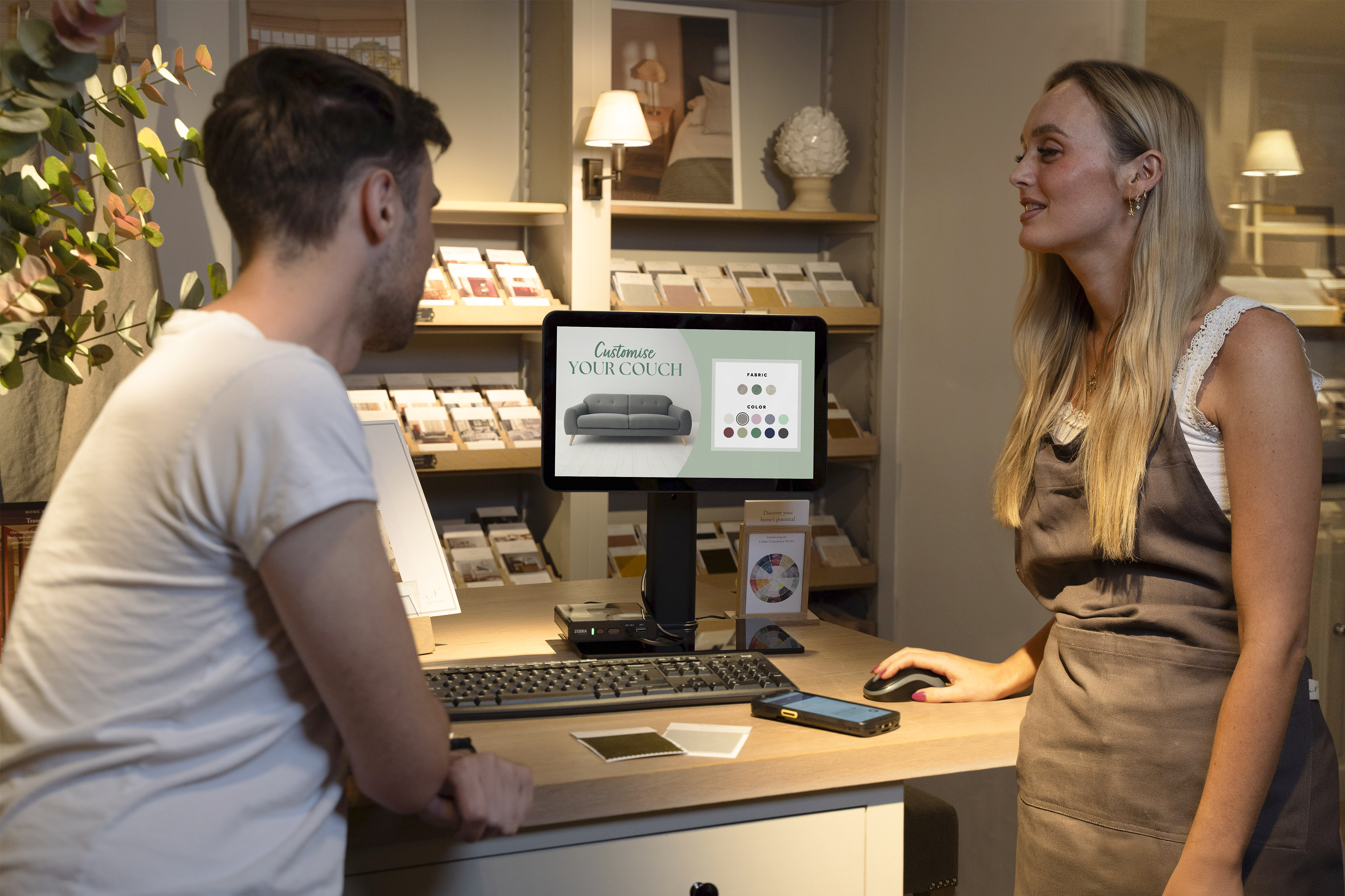 Retail worker using ZE500 with TC50, TC53 and Wireless Workstation Connect to assist with selling