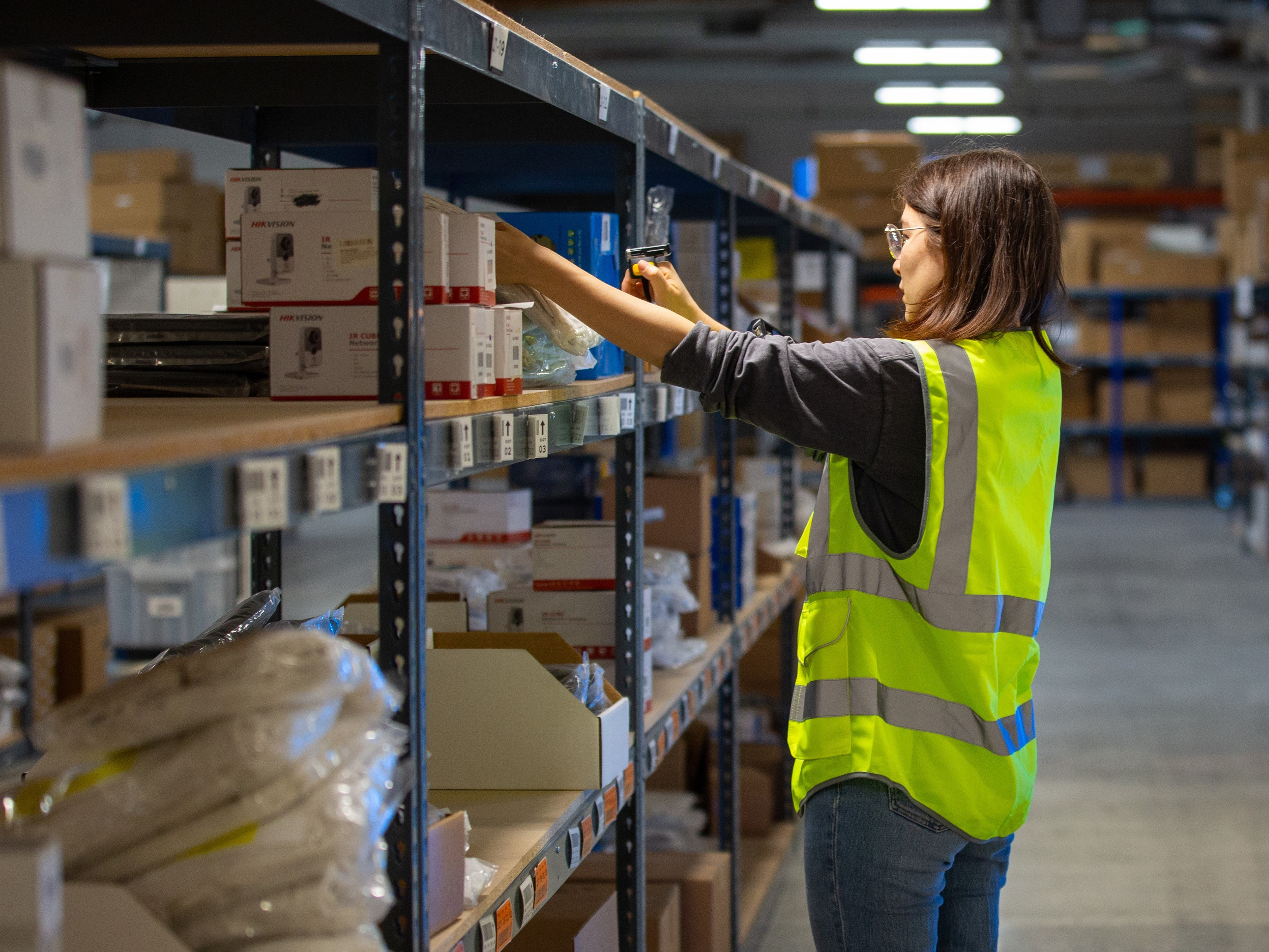 Warehouse worker packing boxes on the shelves at a warehouse