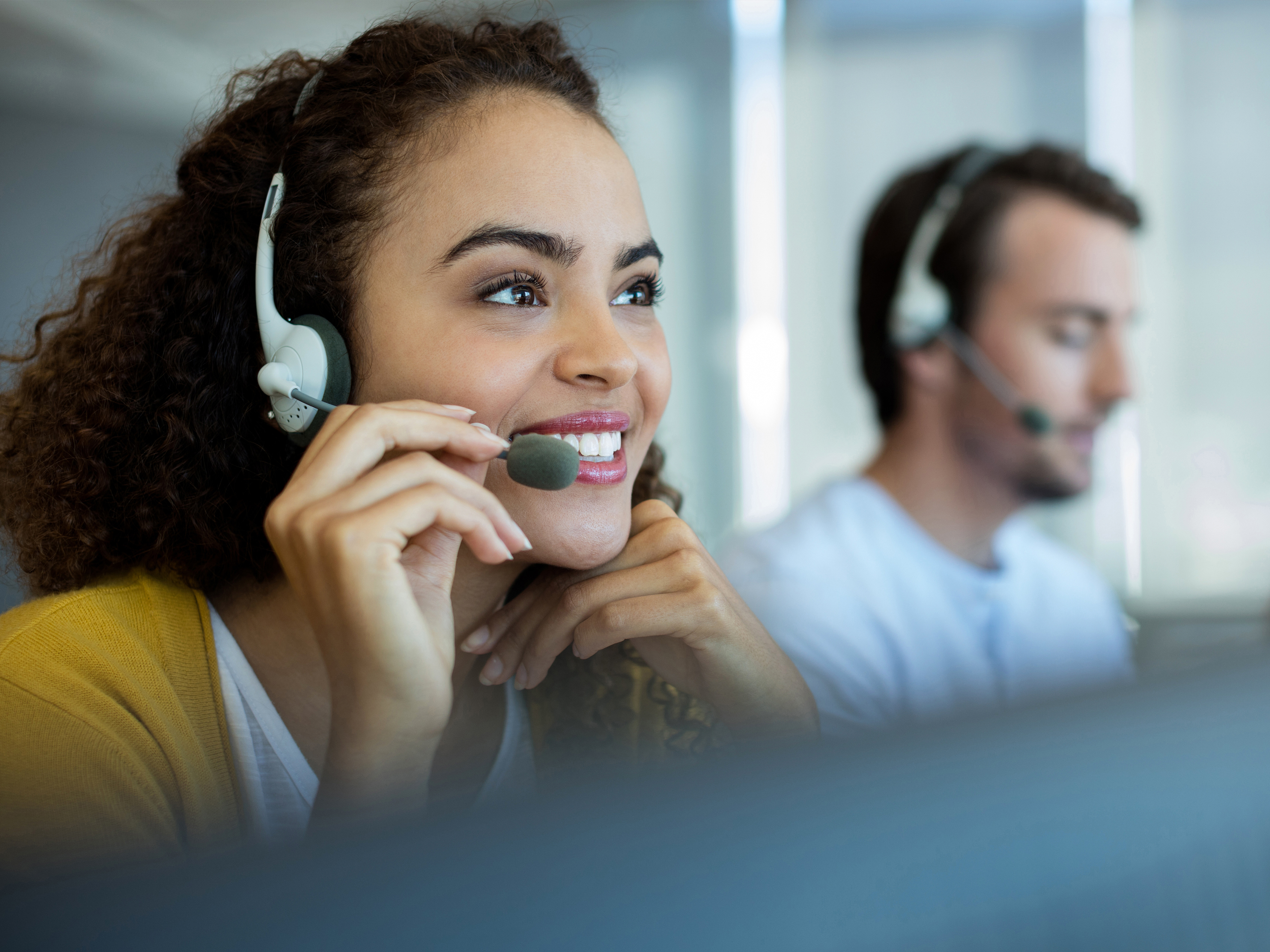 Customer support agents at work using a headset with microphone