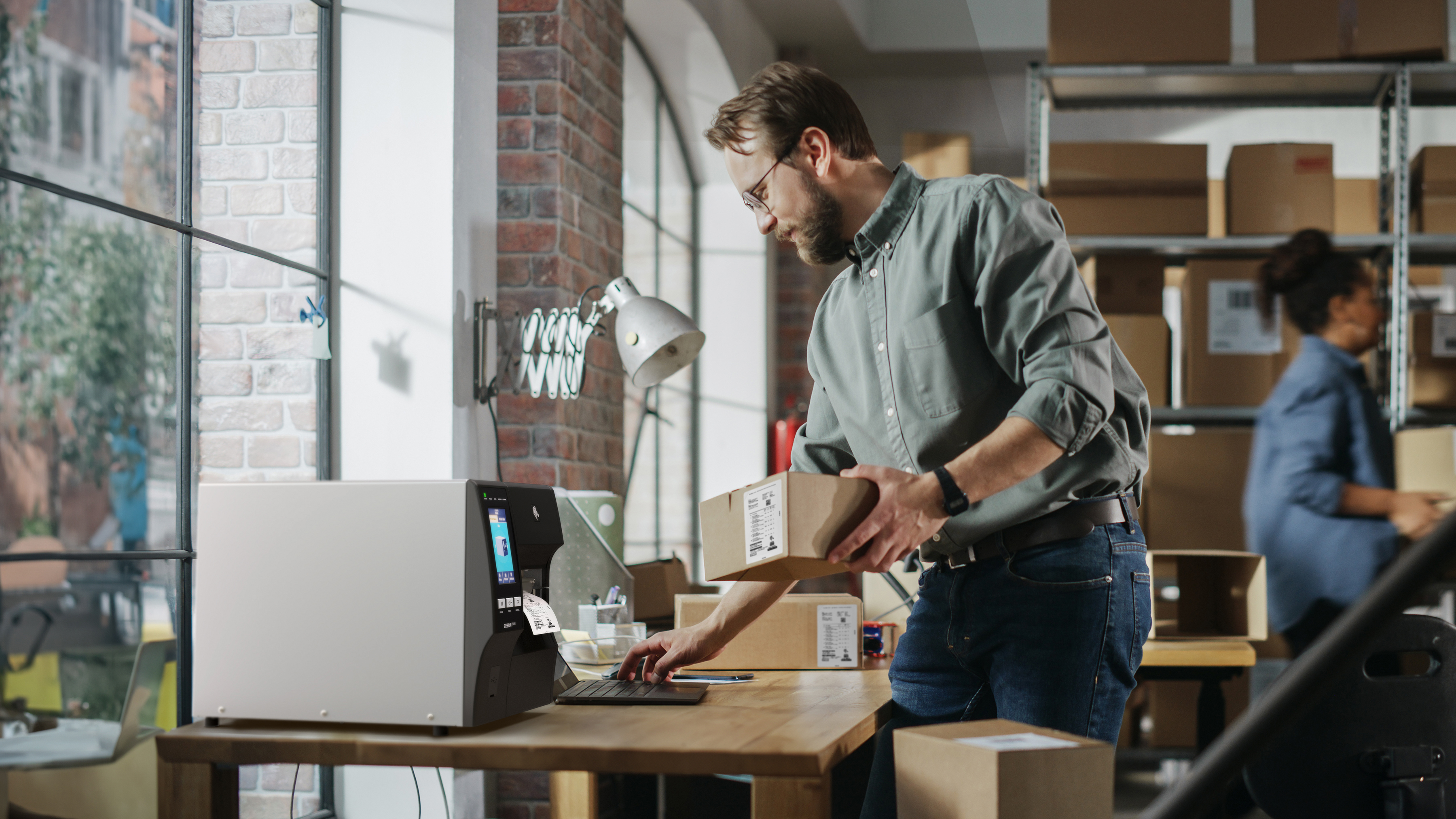 Small business owner printer a label using a Zebra Industrial Printer.