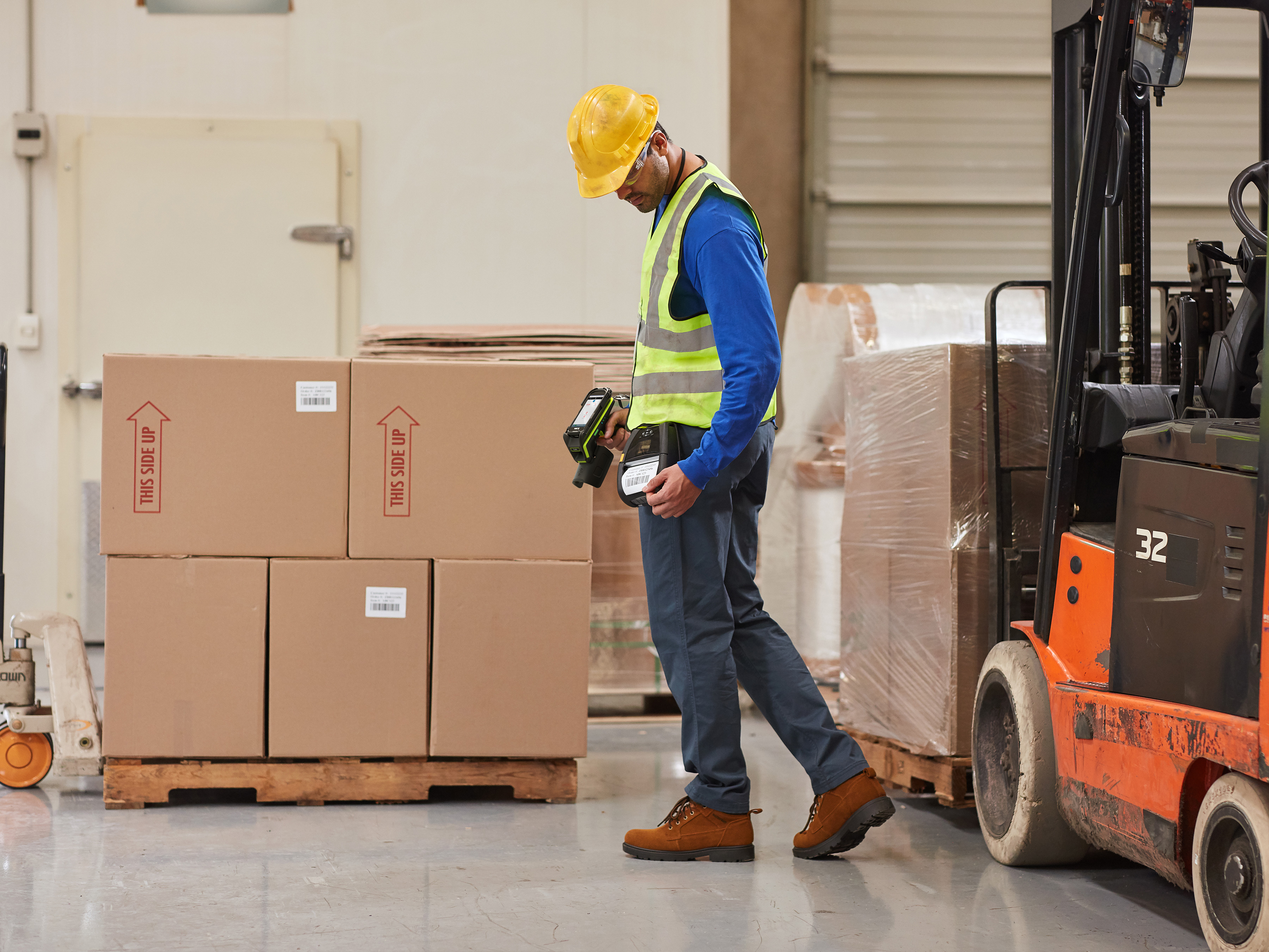 Warehouse working using a Zebra mobile printer to create a packing label.
