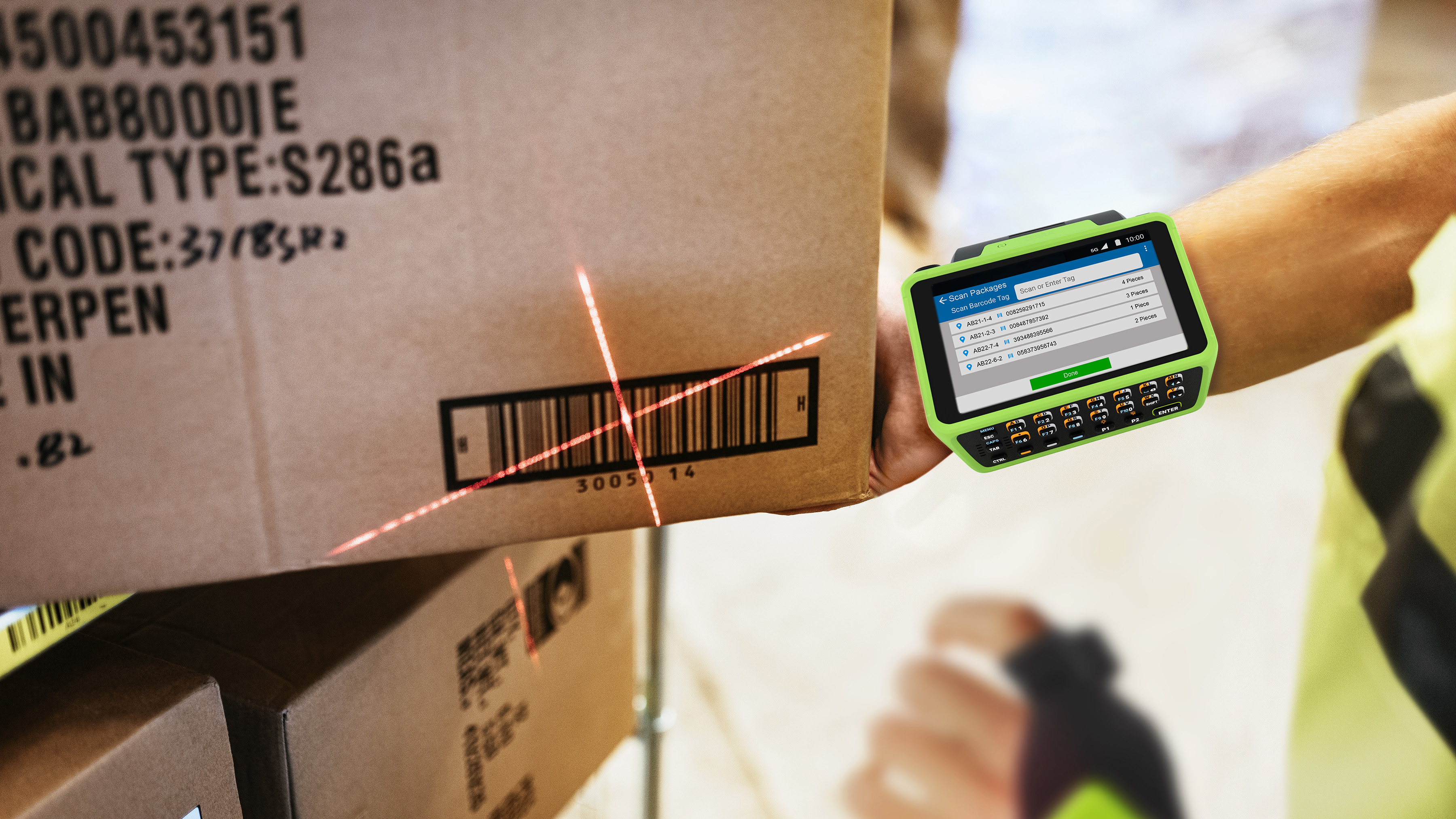 Warehouse worker wearing a Zebra wearable computer to scan a box barcode.