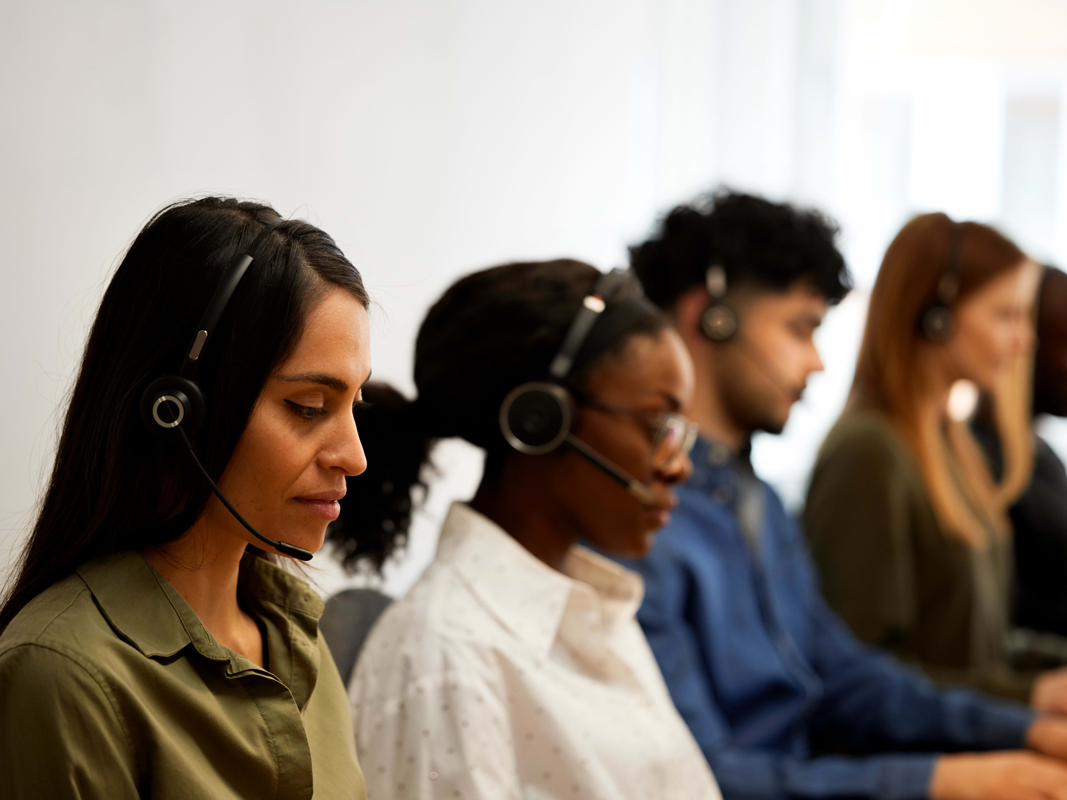 Call center employees working at their desks.
