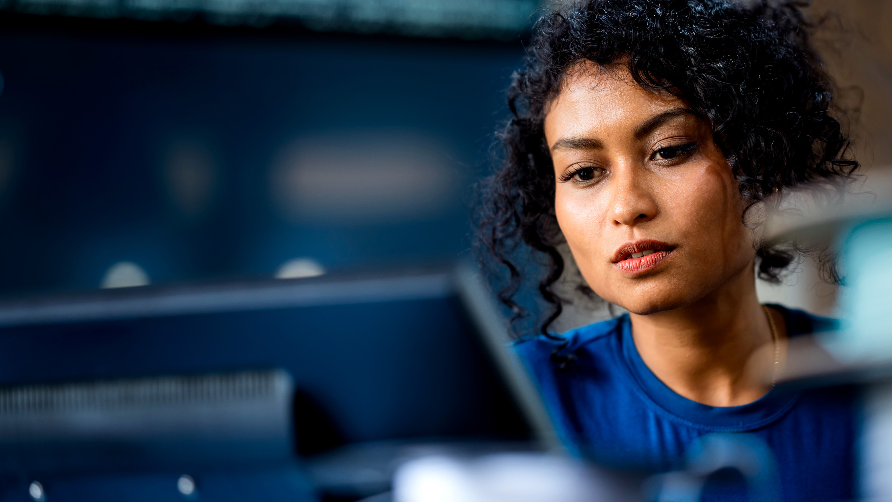 A person looking at a computer workstation.
